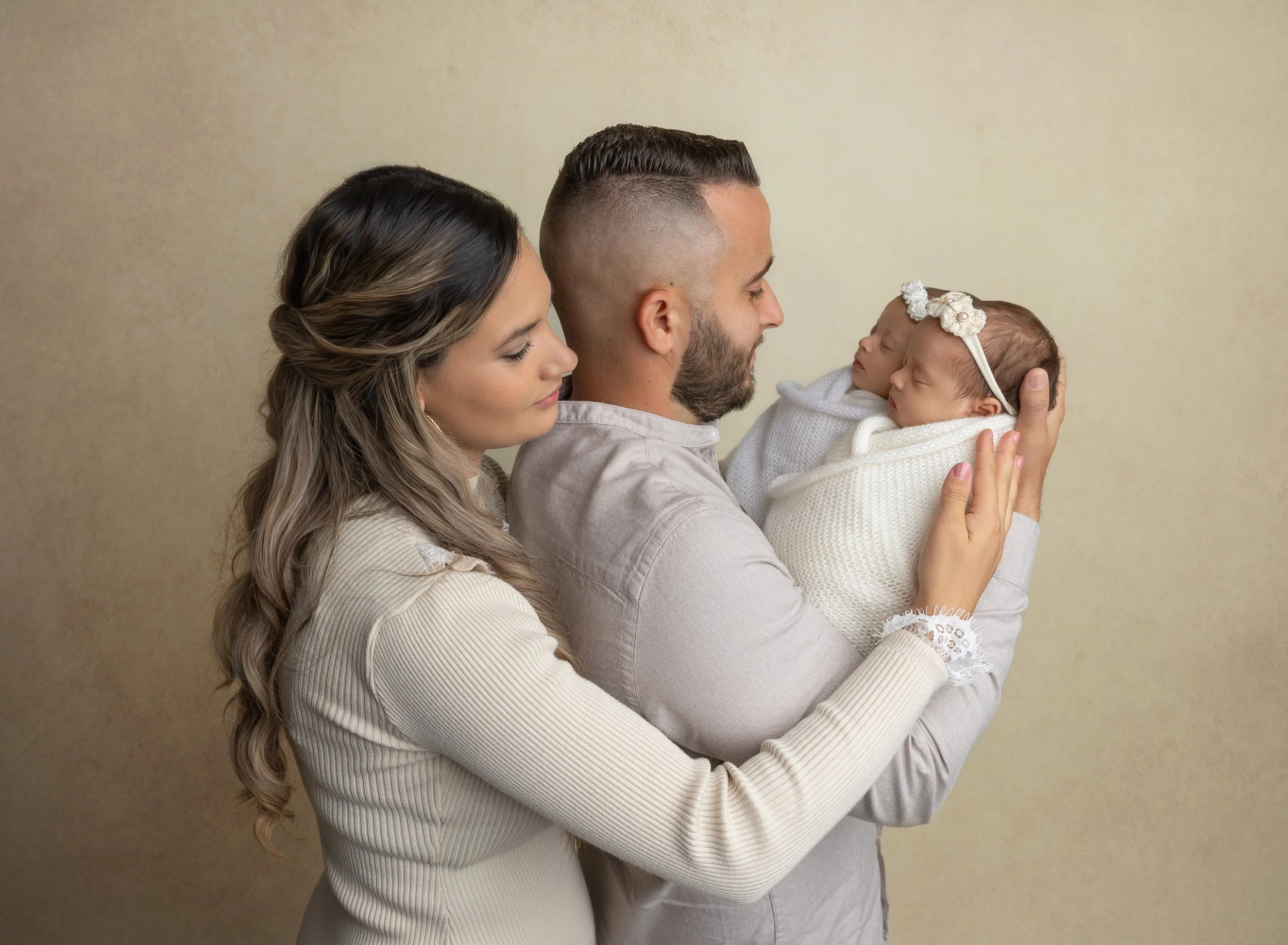 Newborn twin girls posed with parents in photo studio North Port, FL
