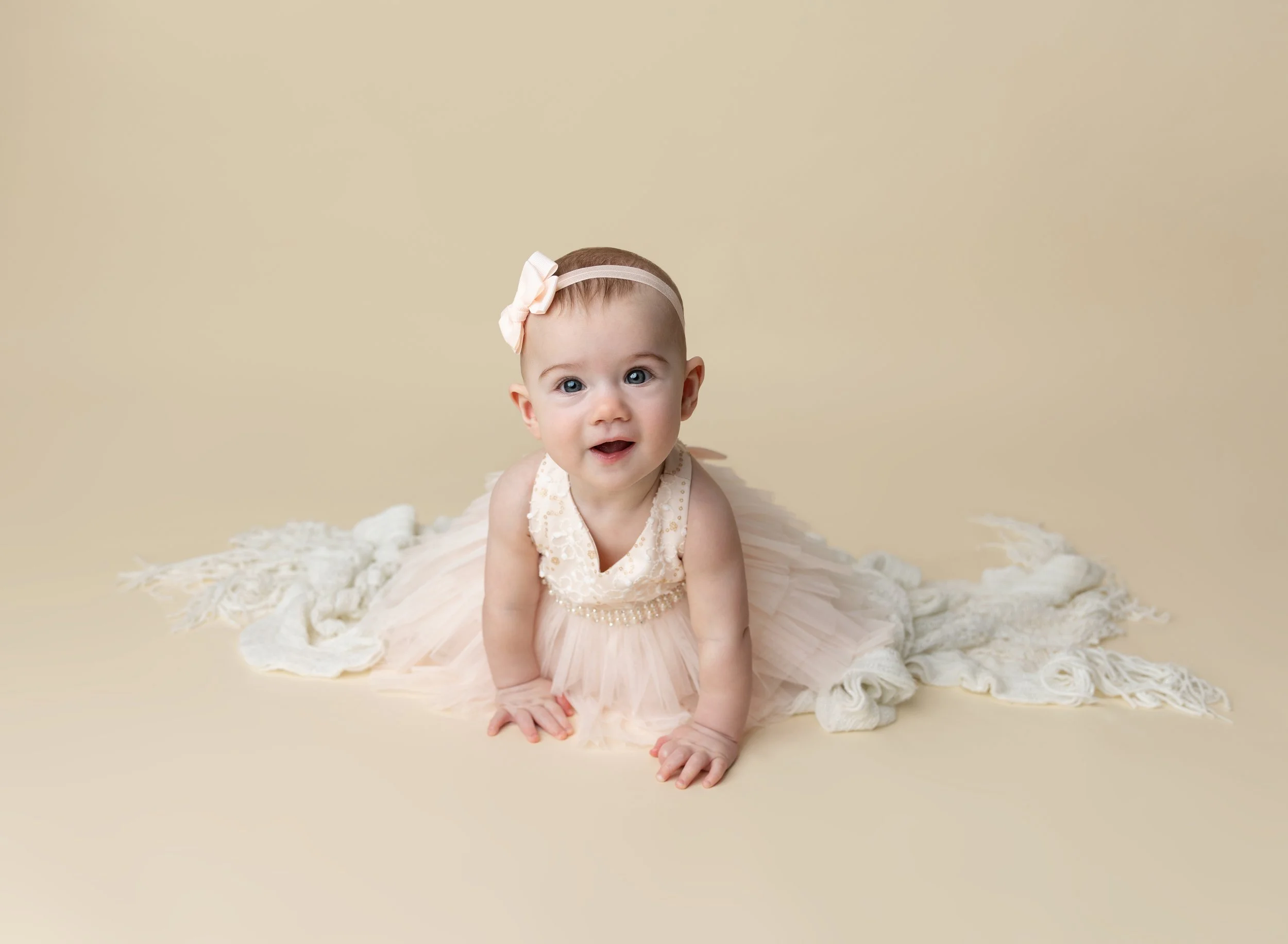 Nine month old girl in pink dress with neutral backdrop Venice FL