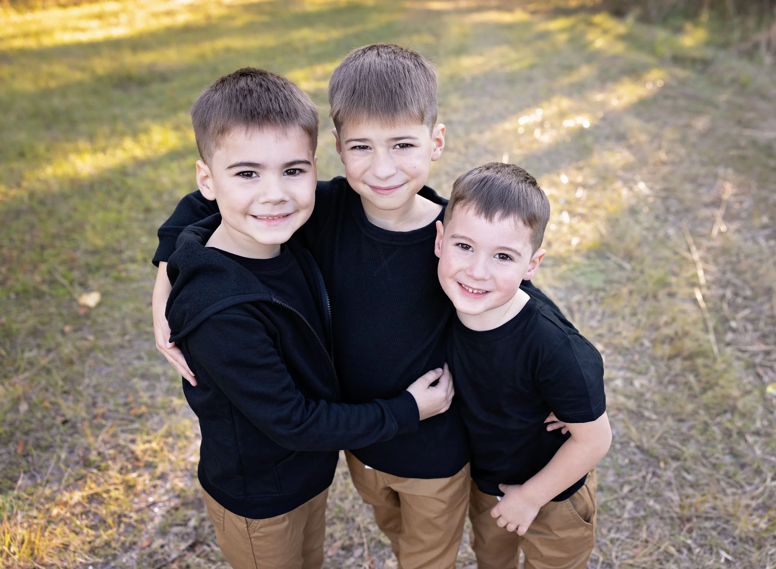 Three small brothers in black at park in Port Charlotte FL