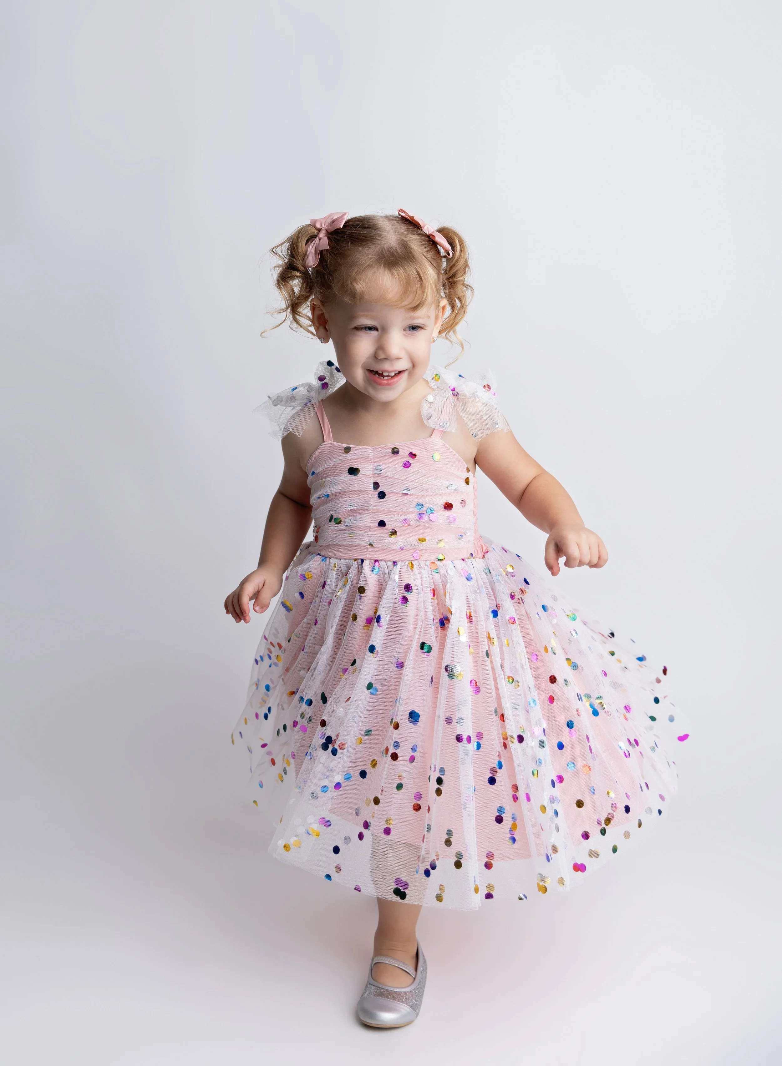 Three year old in pink dress on cream backdrop in North Port FL photo studio