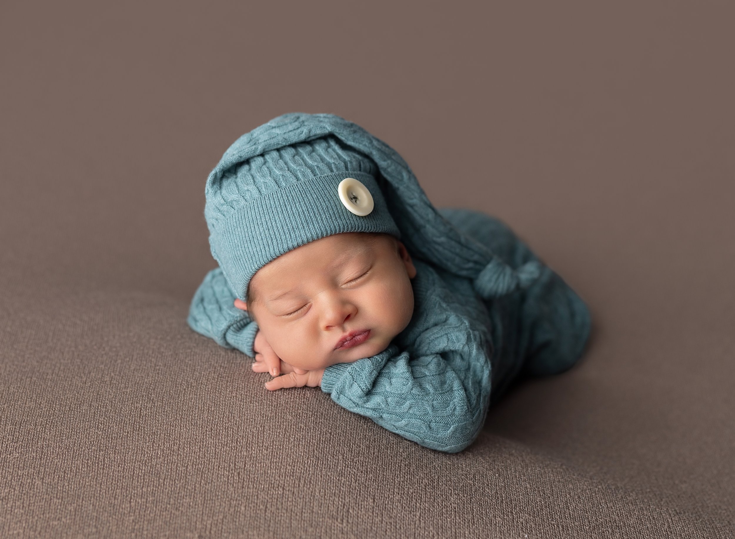 Newborn boy in sage outfit in photo studio North Port Fl