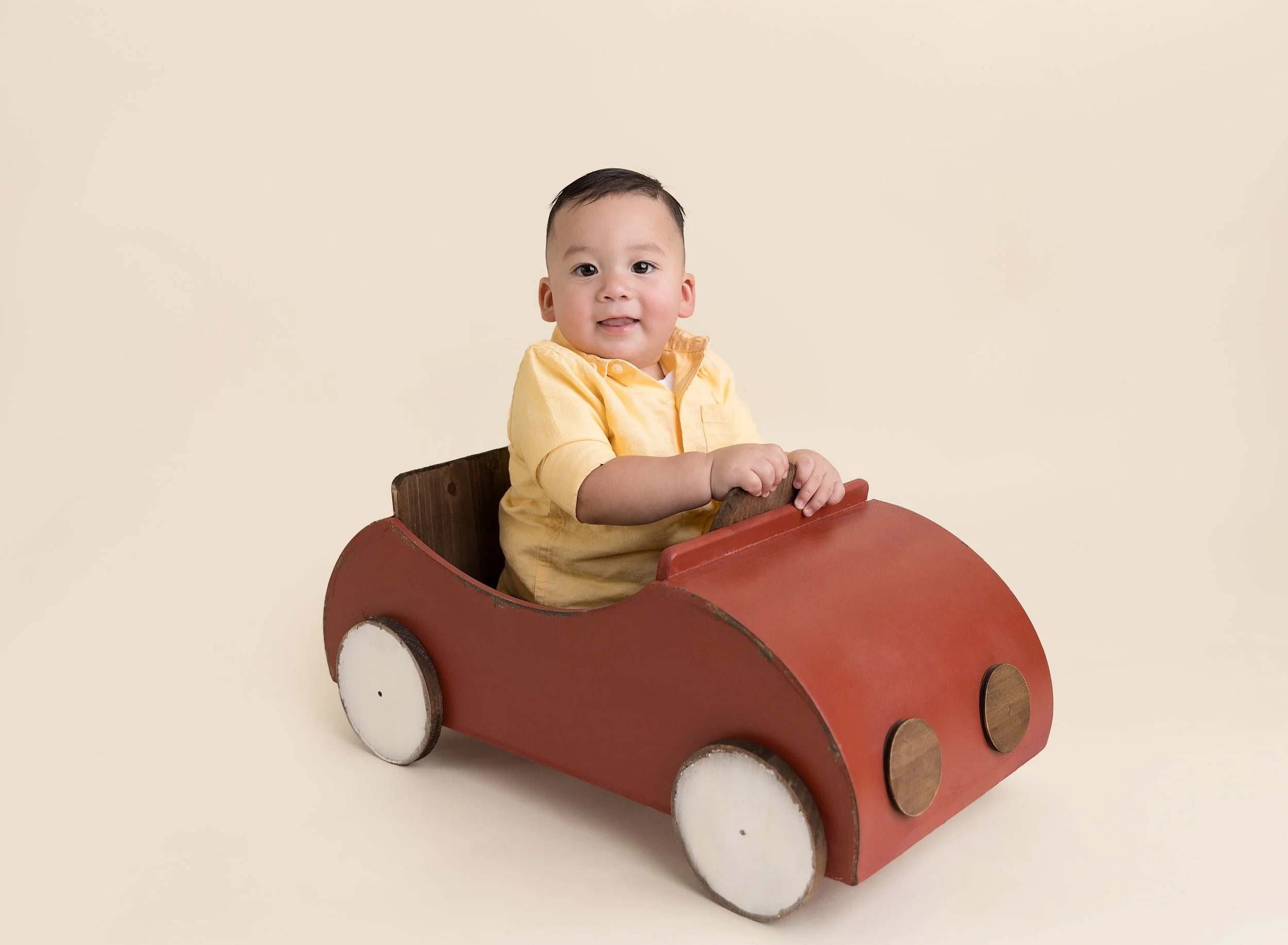 First birthday photo session with boy in red car prop in North Port FL photo studio