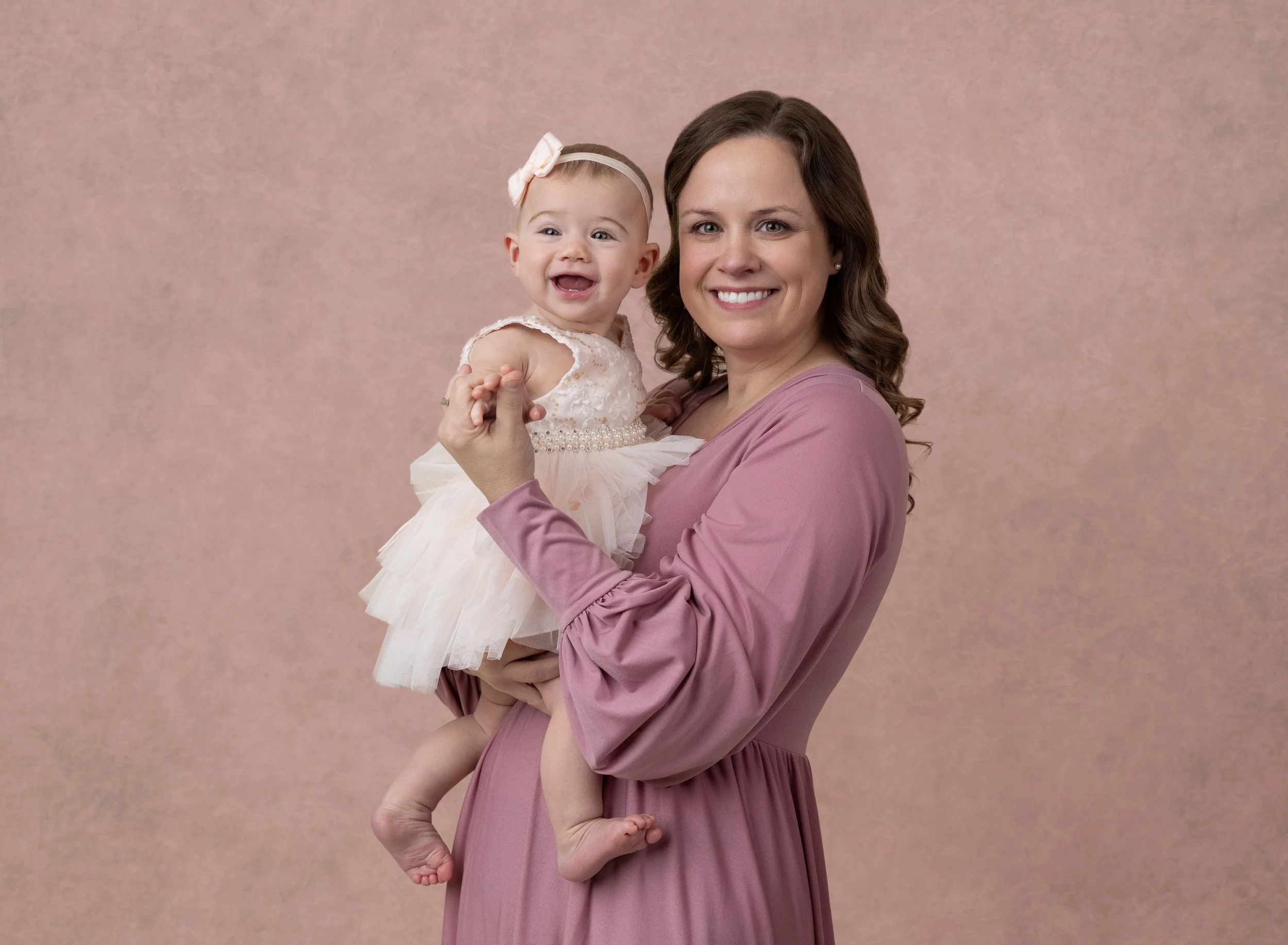 Nine month girl with mom in pink in Port Charlotte photo studio
