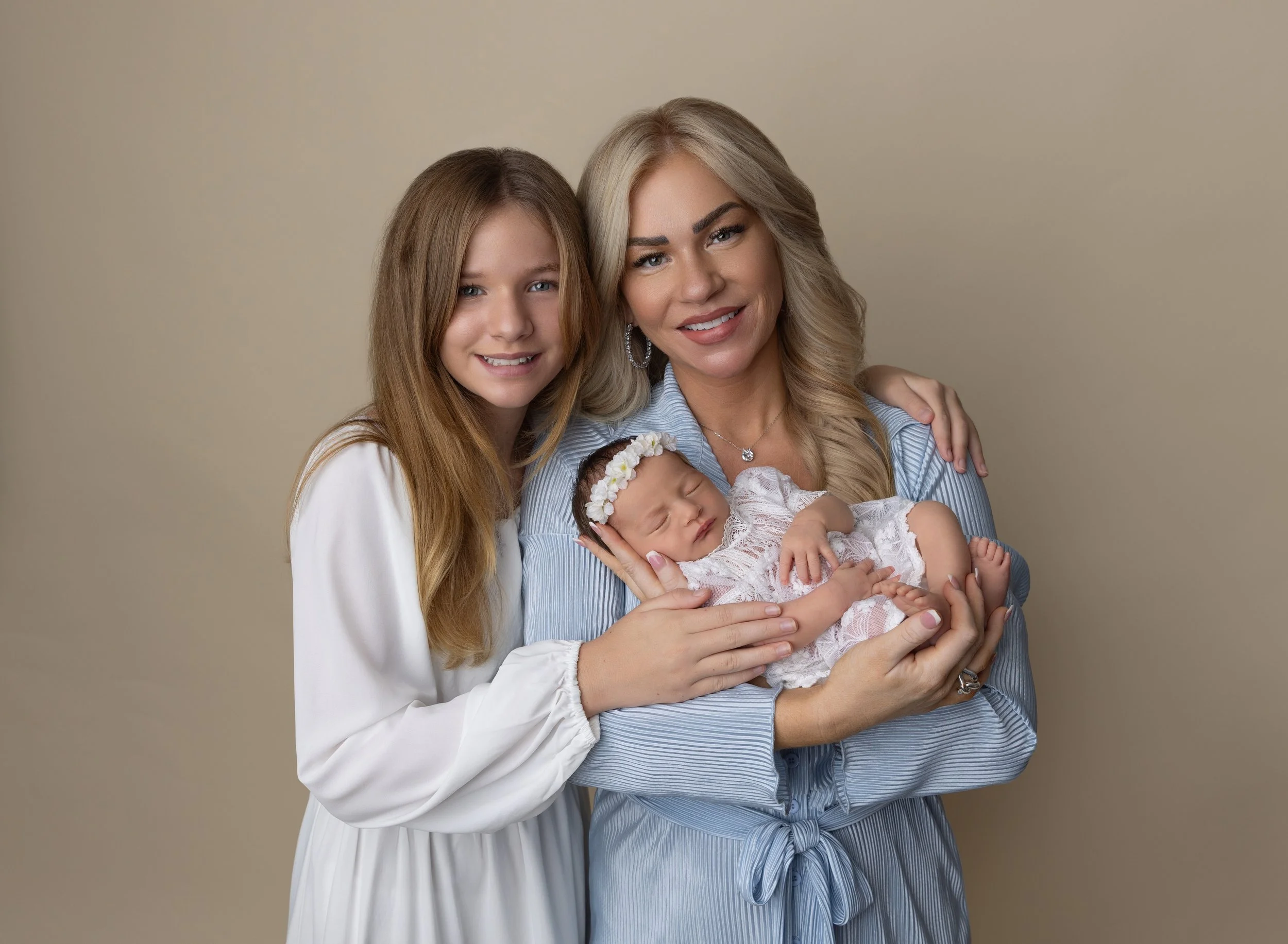 Newborn girl in cream with mom and sister in North Port FL photo studio