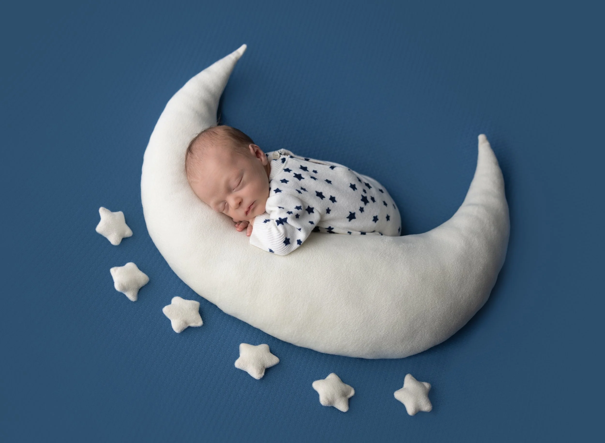 Newborn boy on moon prop and star outfit Port Charlotte photo studio