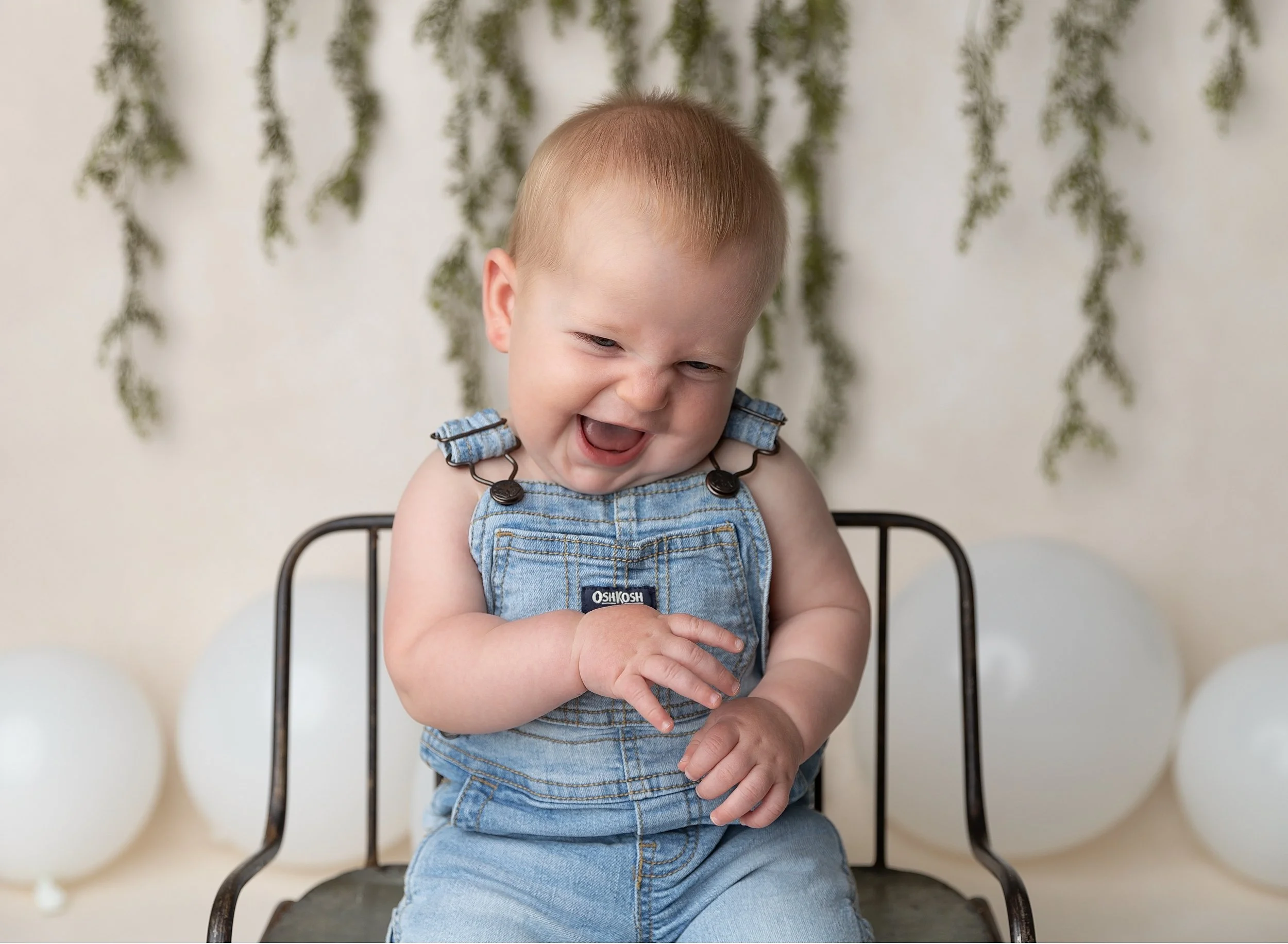 Seven month old boy in overalls in Fort Myers photo studio