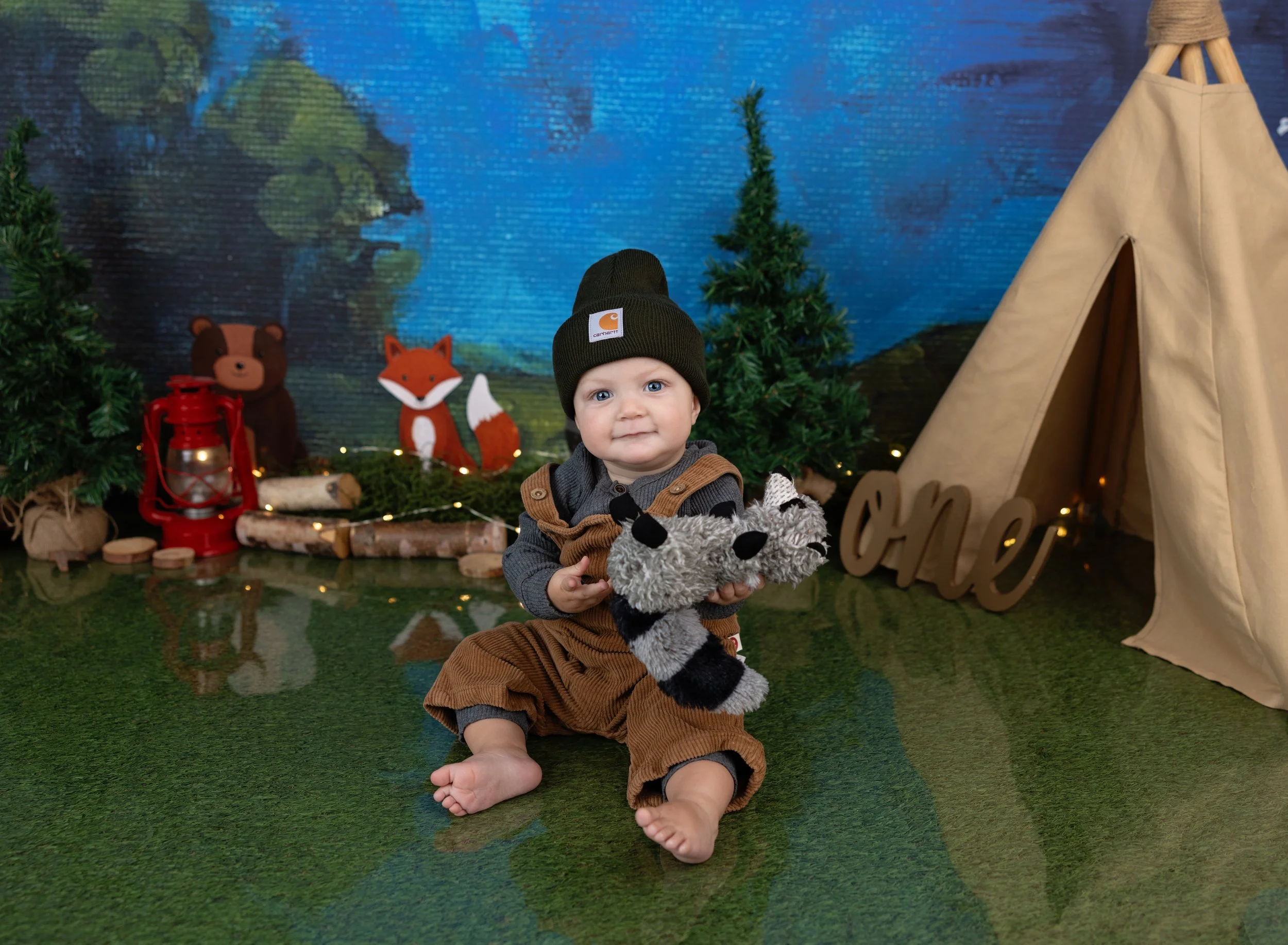 First birthday boy on camping backdrop and overalls in photo studio North Port, FL