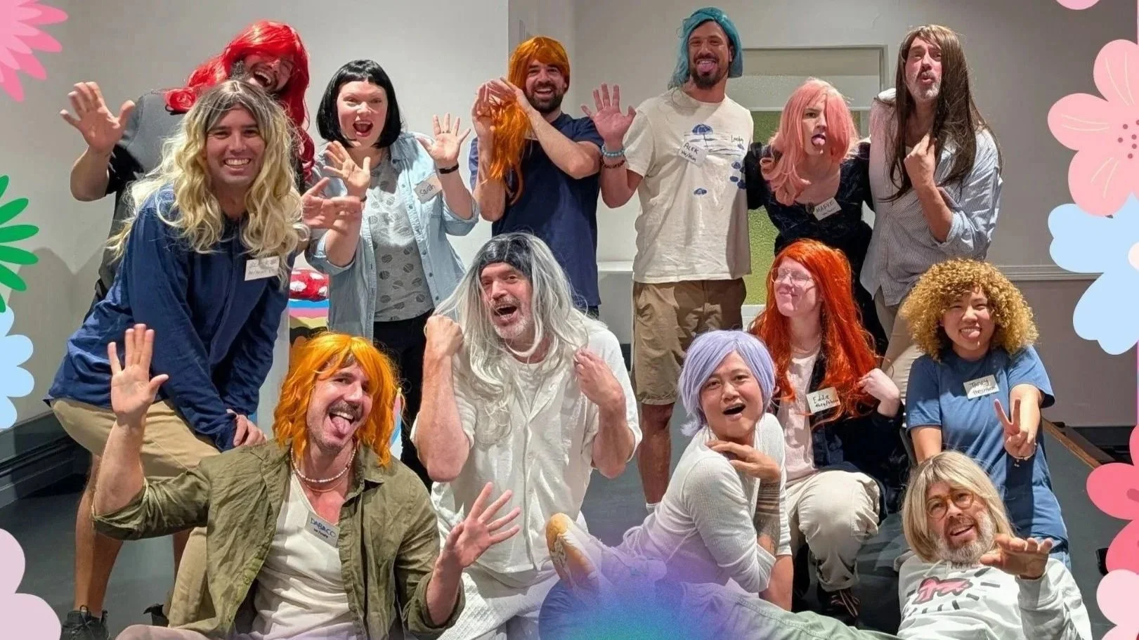 A joyful group of participants in colourful wigs at a Contact High workshop, illustrating community connection, relational play, and expressive group therapy facilitated by Mathew Bergan