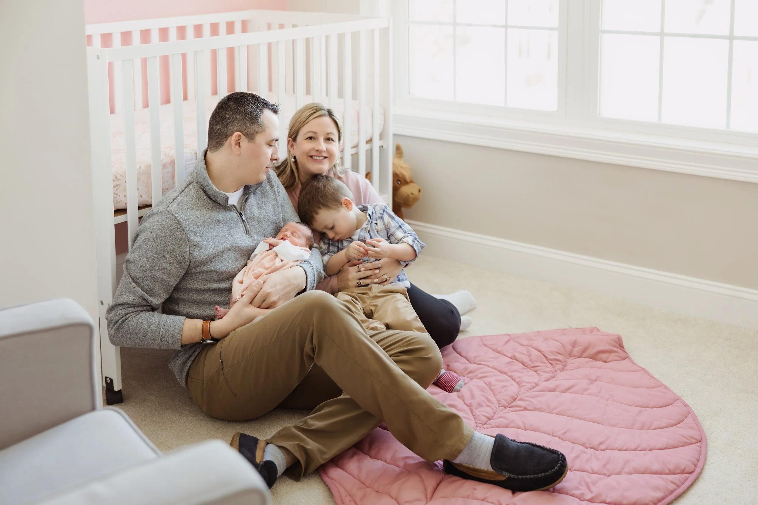   In-home newborn session in Plaistow NH with family cuddling and minimal background distractions  