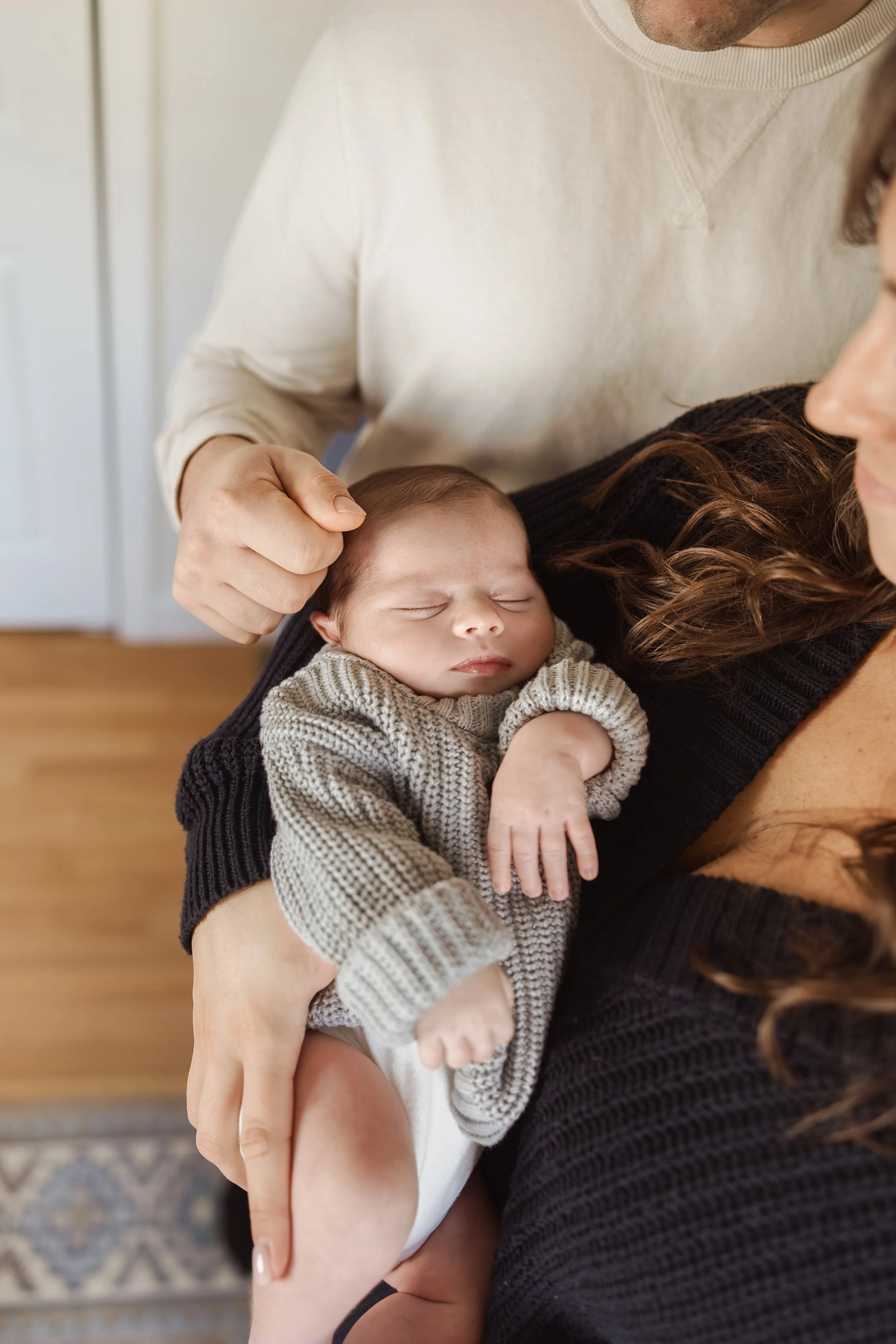 Close-up of family hands during authentic lifestyle family session in Rockingham County NH