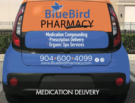Back of Blue Bird Pharmacy vehicle with logo, contact information, and services listed, including medication compounding, prescription delivery, and organic spa services.