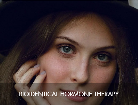 Close-up of a woman with blue eyes, light brown hair, and a hand near her face, with the text 'Bioidentical Hormone Therapy' overlaid.