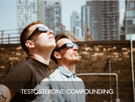 Two men standing outdoors in an urban setting wearing solar eclipse glasses, looking up at the sky, with city buildings in the background. The text 'Testosterone Compounding' is overlaid at the bottom.