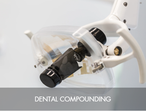 Close-up of dental equipment used for dental compounding, including a magnifying glass and other tools.