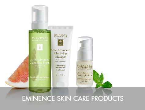 Three Eminence skin care products with grapefruit and mint leaves beside them