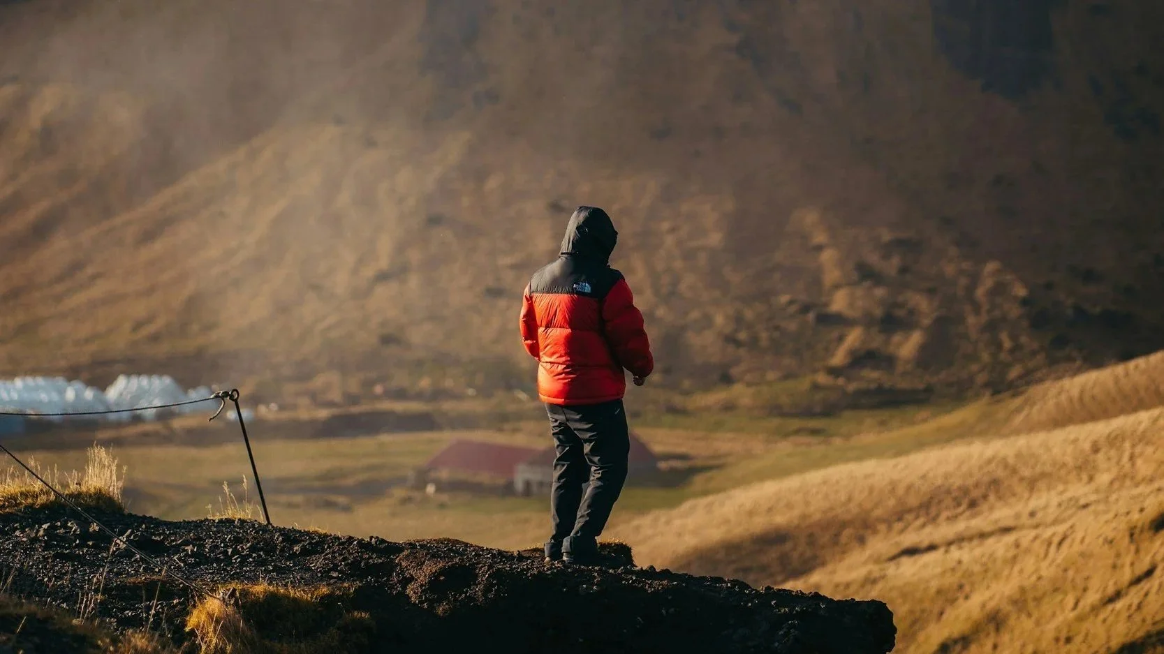 Person sitting on the sand and drawing a horse track from a worksheet titled 'The Ancient Art of Tracking' with instructions and illustrations.