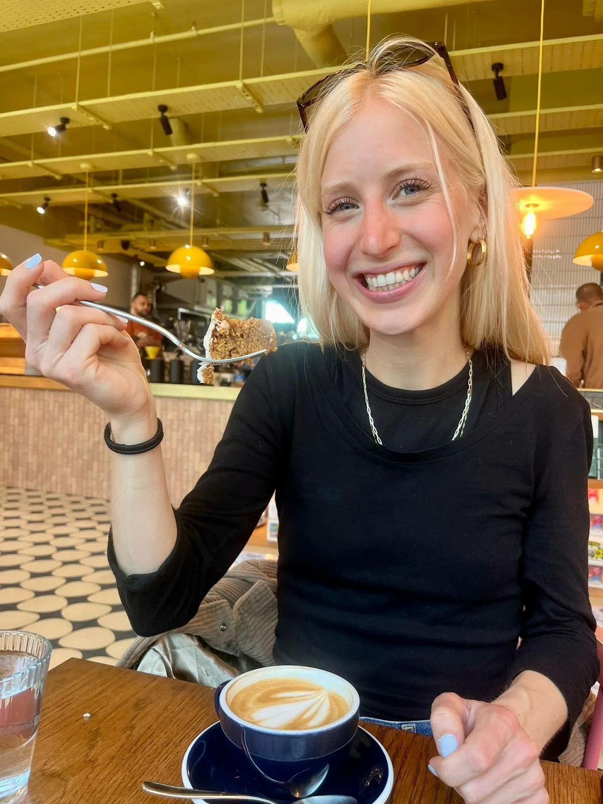 Georgia enjoying a coffee in a cafe