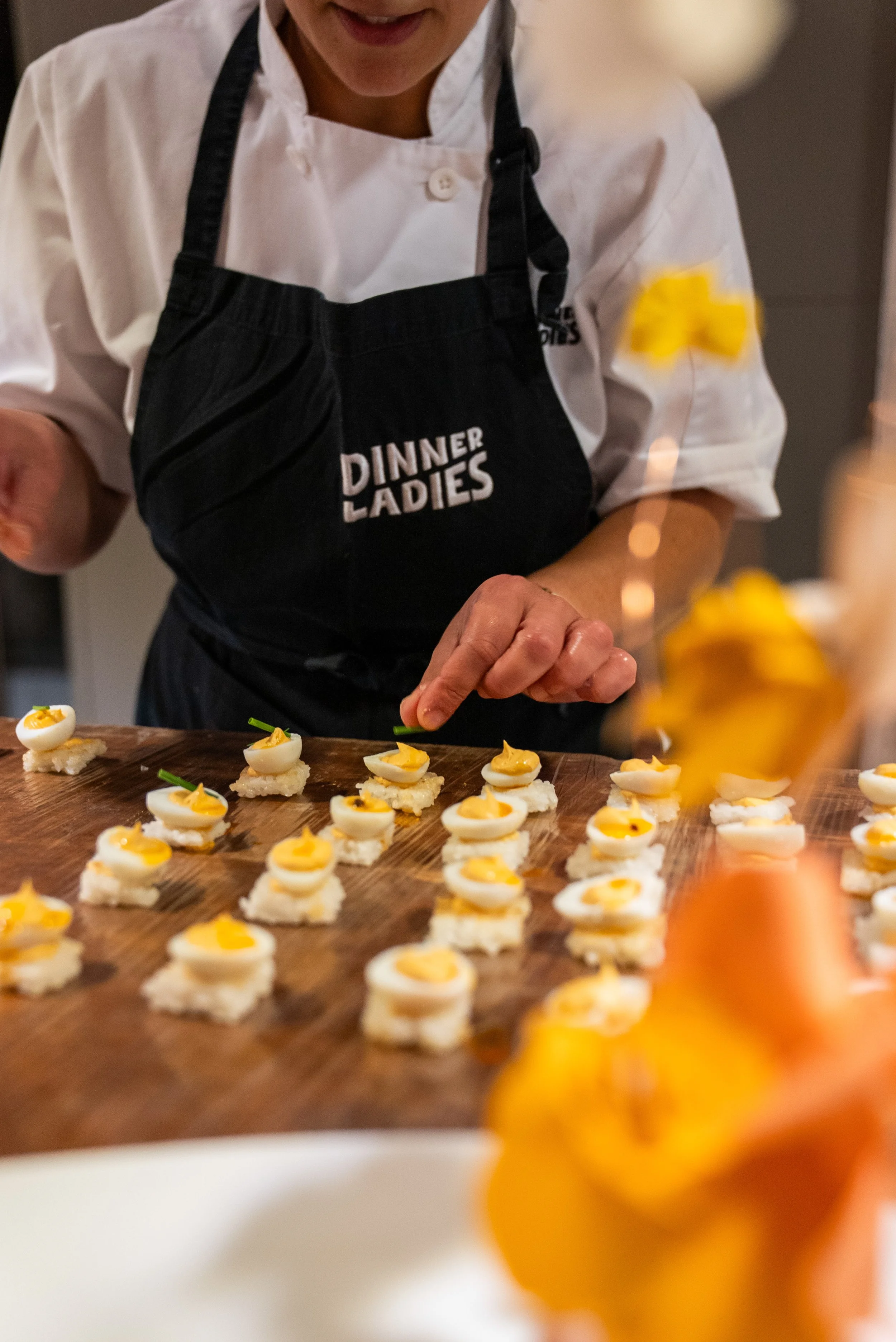 Canapes being finished off by chef before being served to guests