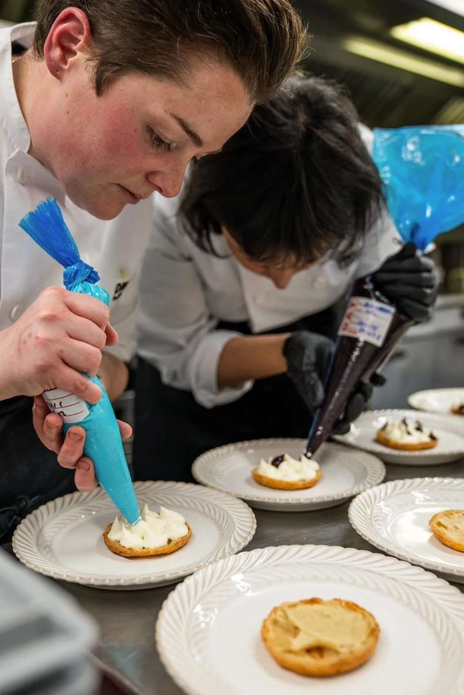 Chefs preparing desserts for guests