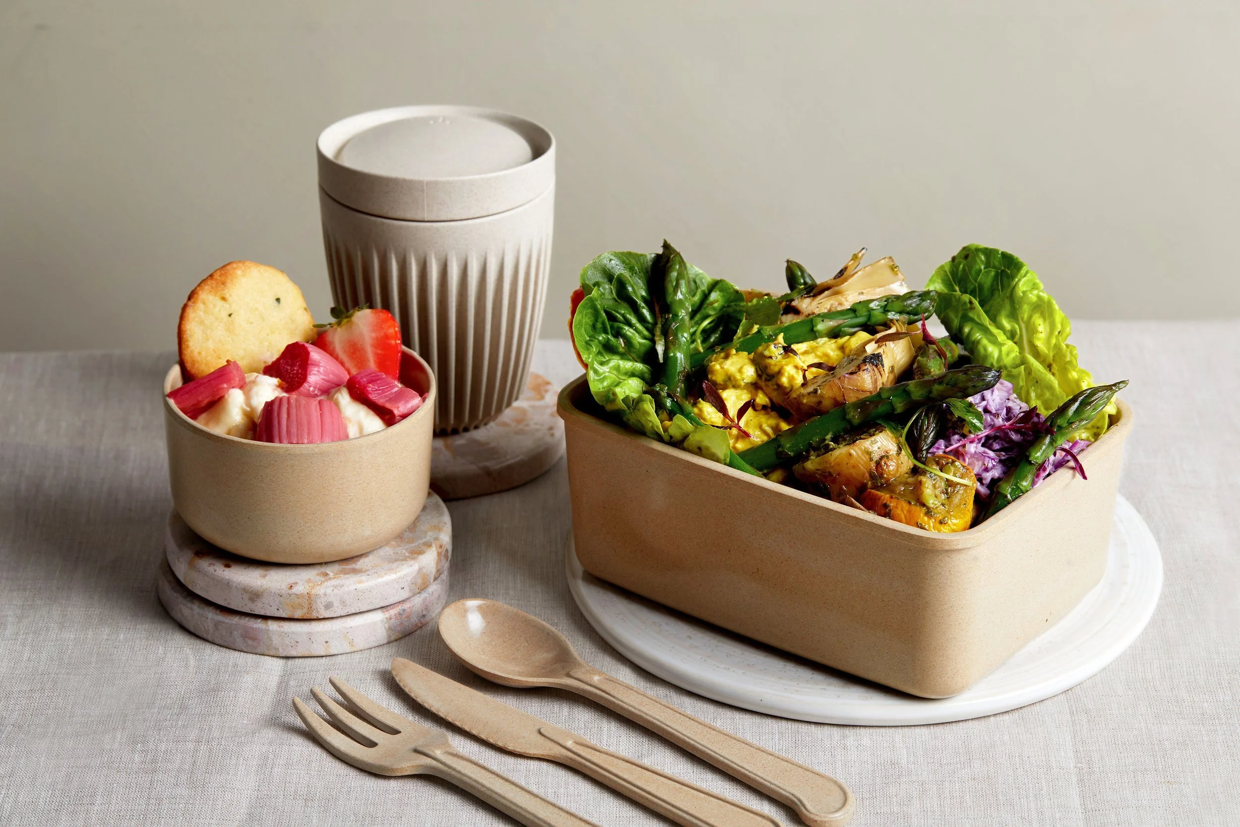 Salad, dessert and drink shown in plant conscious service equipment