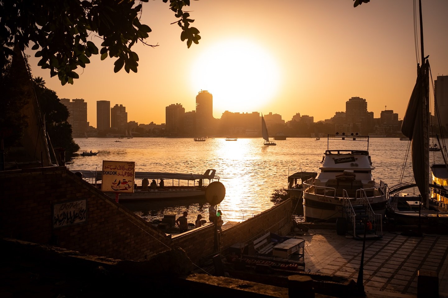 The city fades into silhouettes as the golden light dances on the water. Boats gently glide by, and for a moment, everything feels still. There&rsquo;s something magical about the way this river meets the city, blending history, beauty, and serenity.