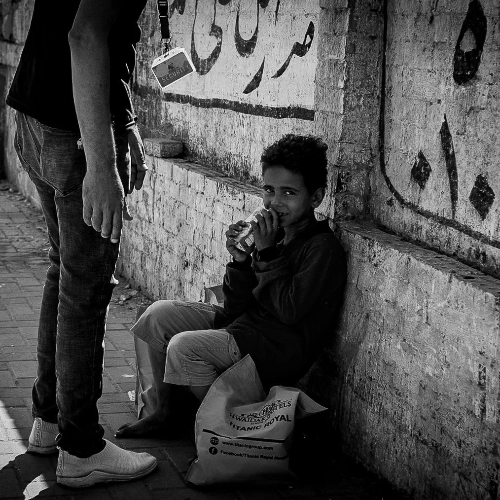 A smile survives even in the shadows.
Kindness, even in its smallest form,
can light up the darkest corners. #egyptstreetphotography #streetphotography #streetlife #blackandwhitephotography #streetstories #egypt #cairo #thisisegypt #everydayegypt #ol
