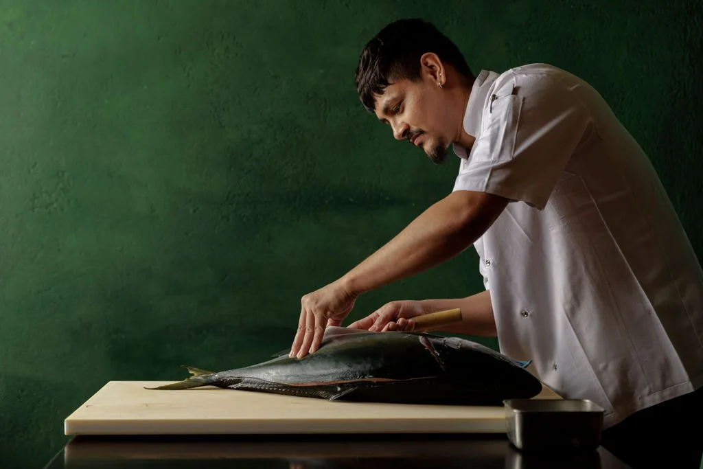 Head Sushi Chef Sandesh Baral preparing yellowtail at Ayllu restaurant, Paddington