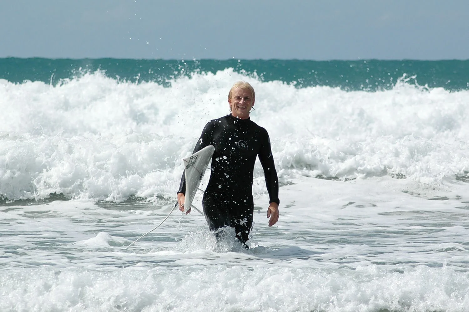 Matt Whaley walking out of the surf