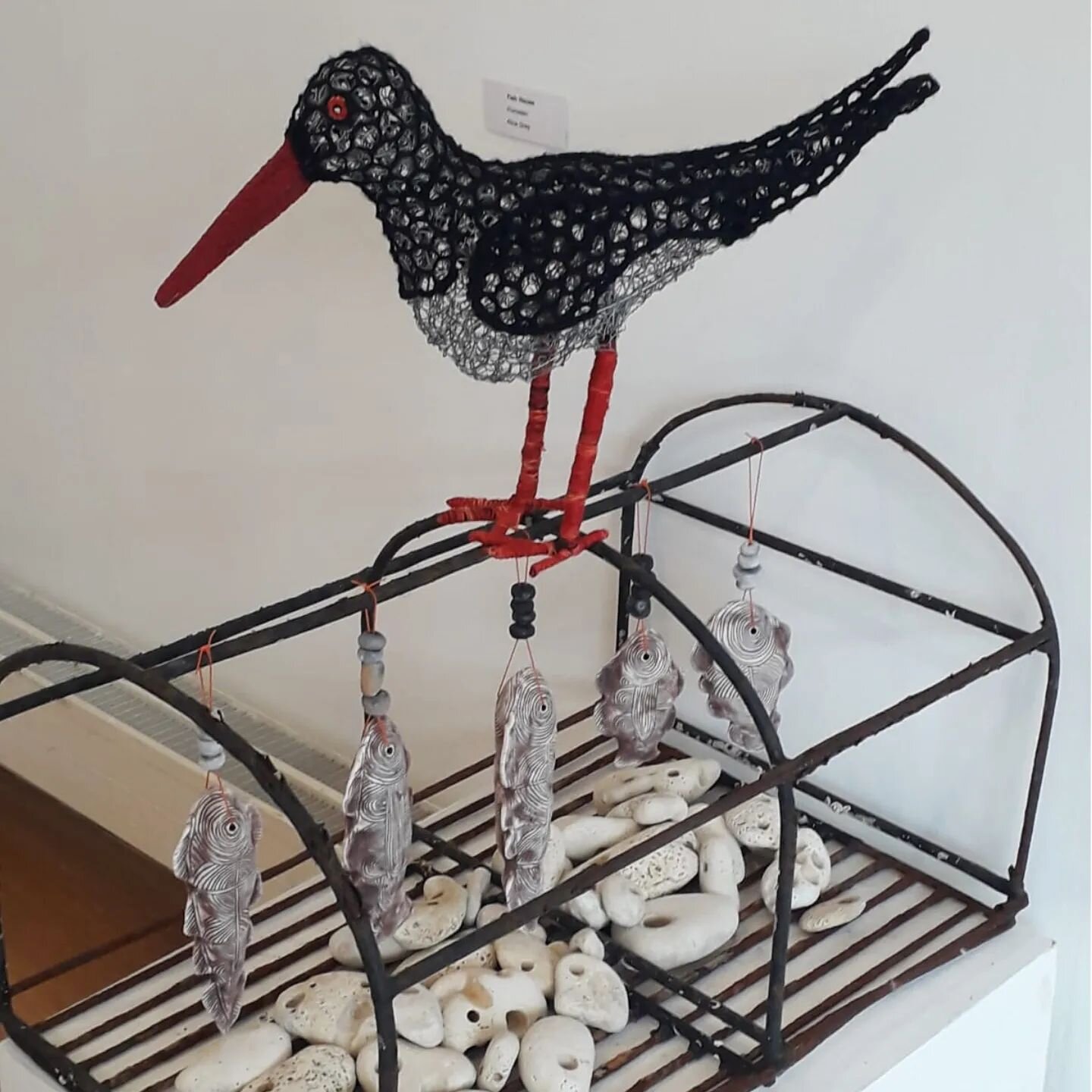 We have a new visitor in our gallery, he has been exploring the wonderful works and cards in our Making Waves exhibition. The show featuring woven wire sculptures by @glynismakesthings, paintings by @helenhawkmoth and ceramics by @selkie_arts is open