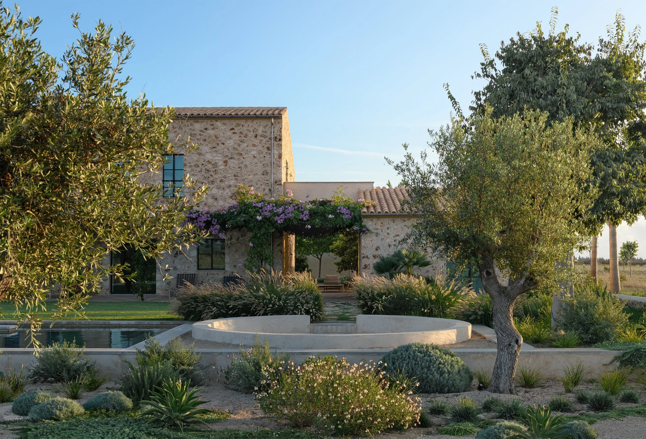 Sunken fire pit lounge and pool with Mediterranean gravel garden