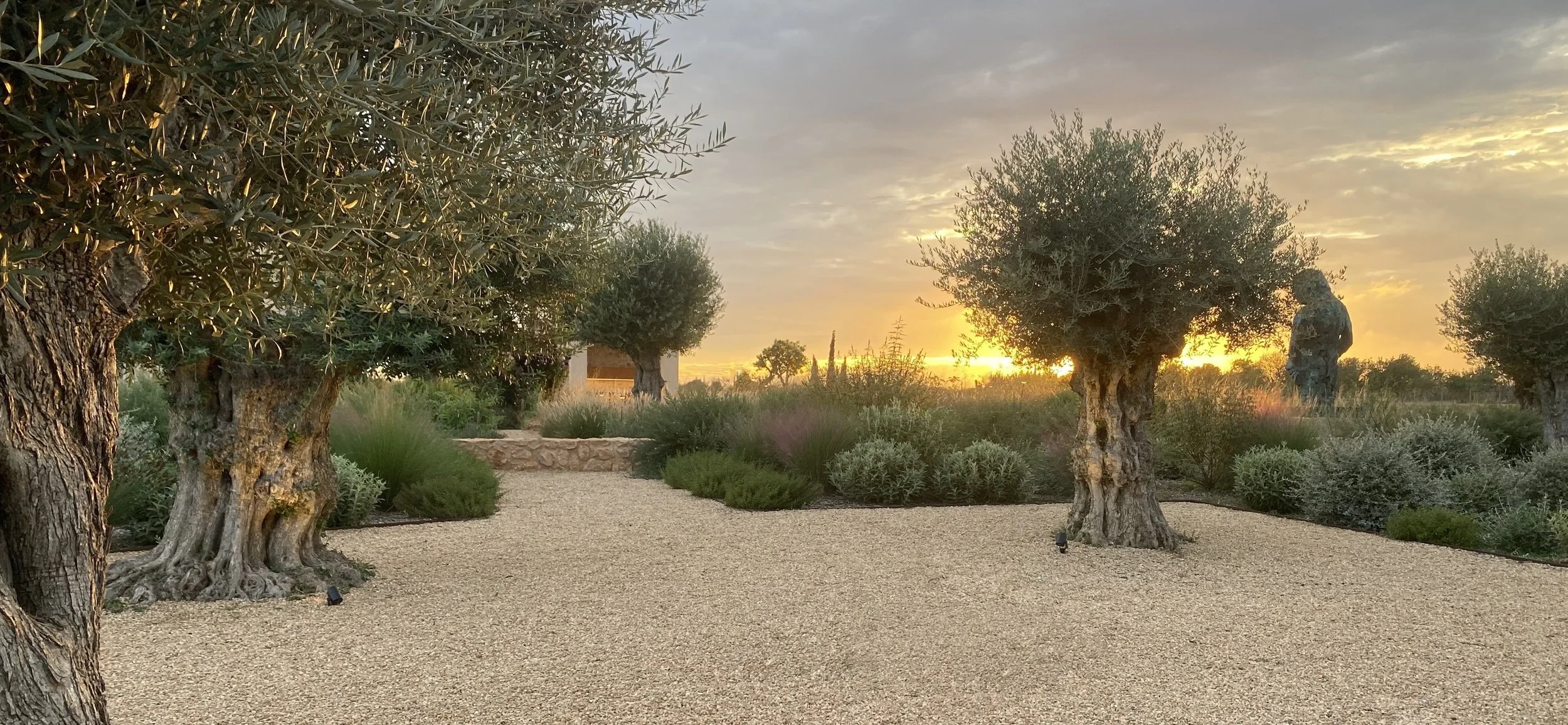 Sunset with bronze sculpture in the landscape