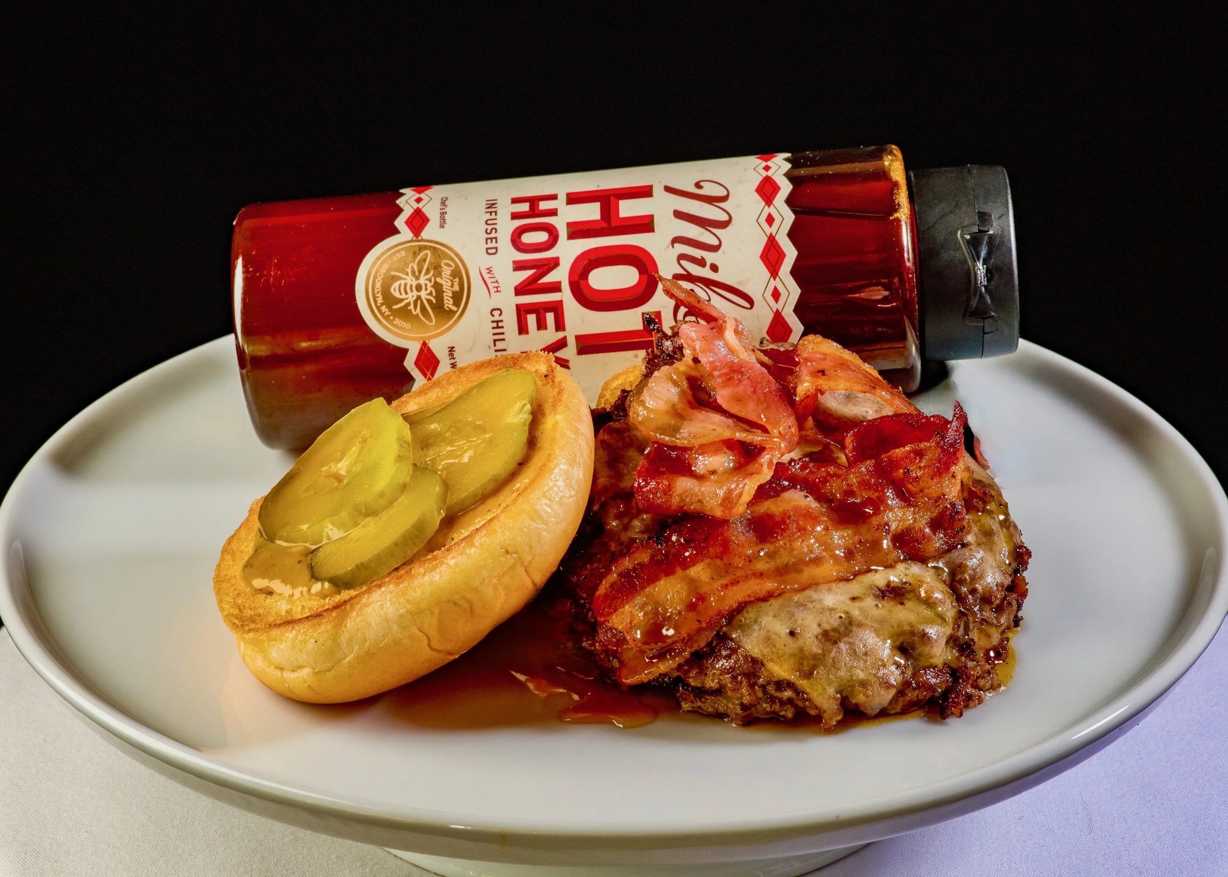  The bacon cheeseburger features a drizzle of hot honey oil 