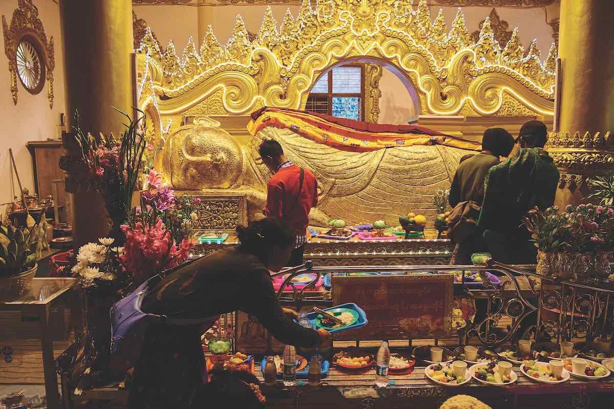 The remains of Lord Alaungdaw Kathapa. The stunning large golden reclining Buddha shrine is covered each year in flakes of gold offered by the worshippers.