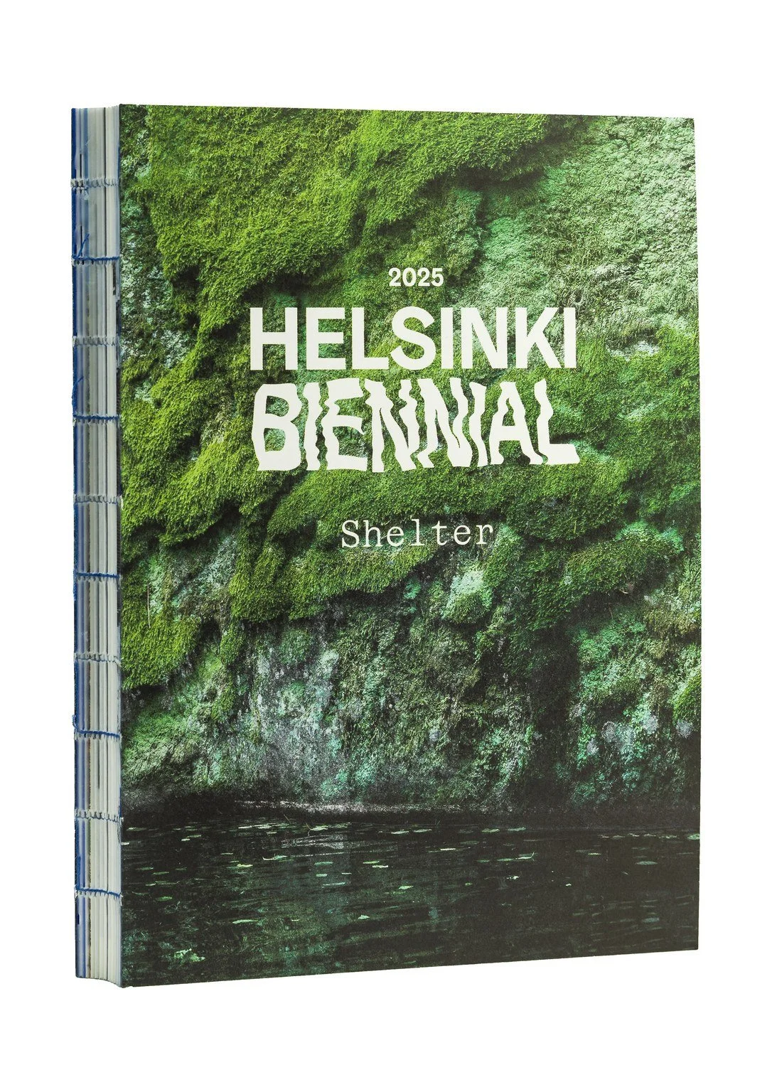 A booklet titled 'Helsinki Biennial 2025 Shelter' with a cover image of green moss-covered rocks and water.