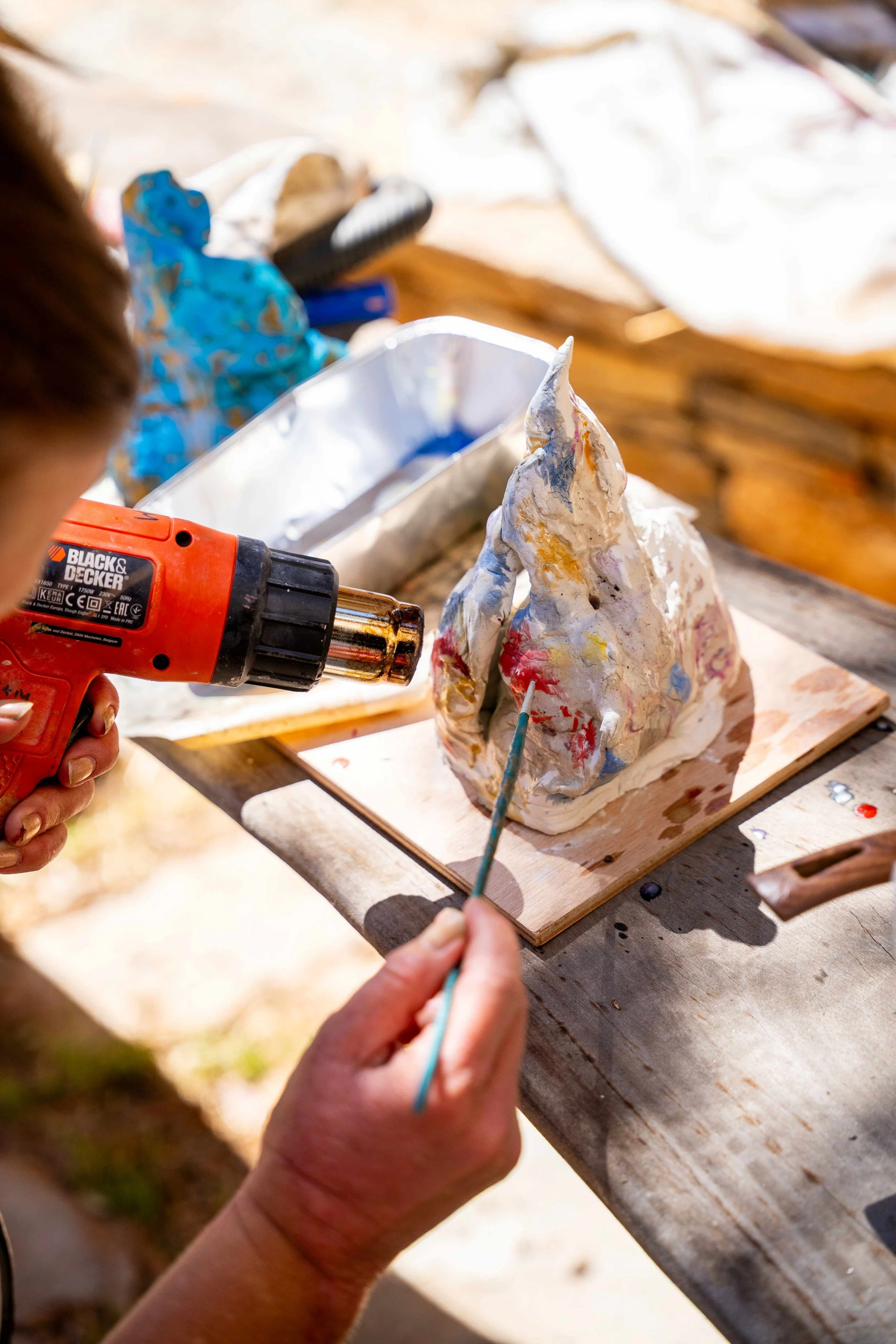 Finnish artist Satu Metsola working with her sculpture outdoors