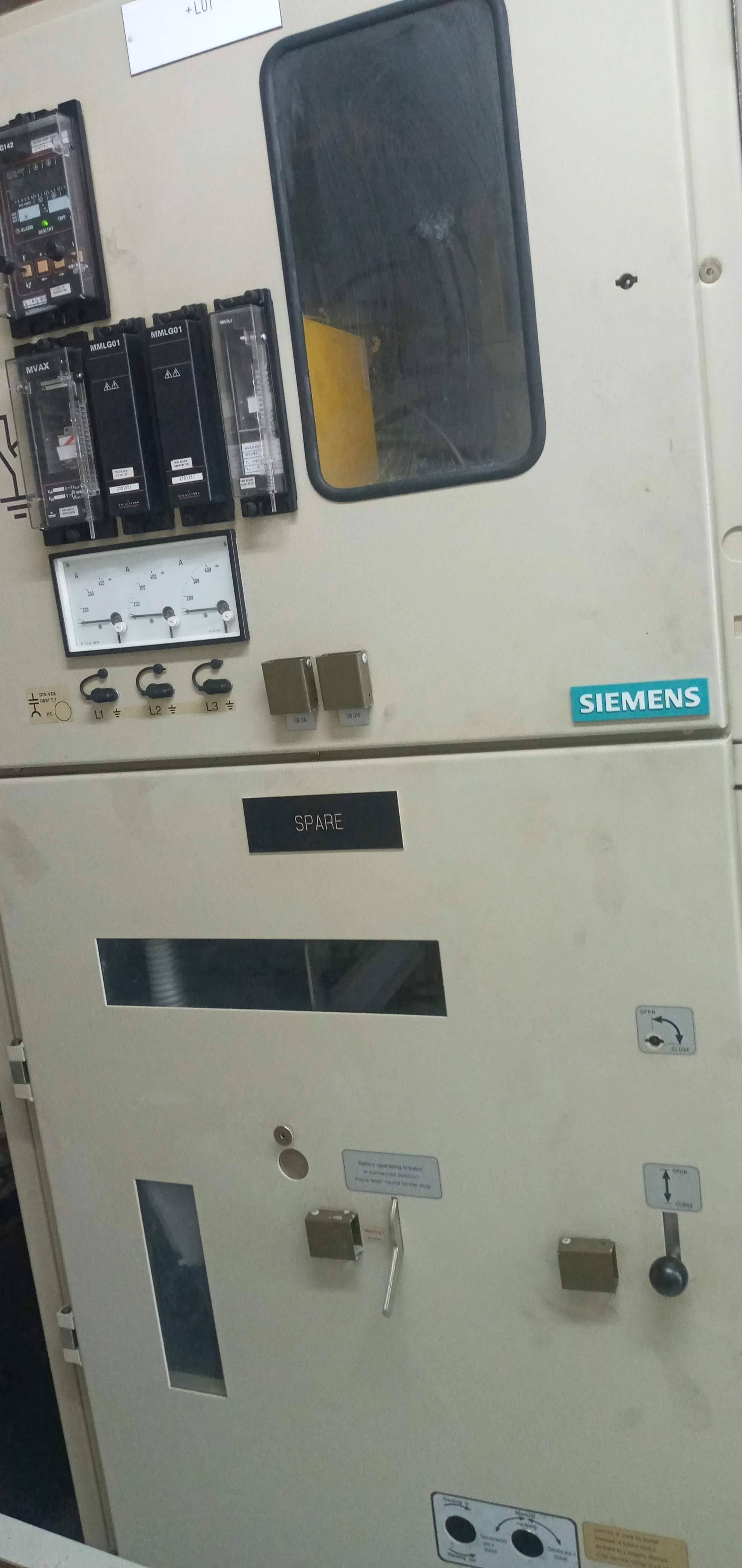 Electrical control panel with a Siemens logo, analog meters, circuit breakers, and switches.