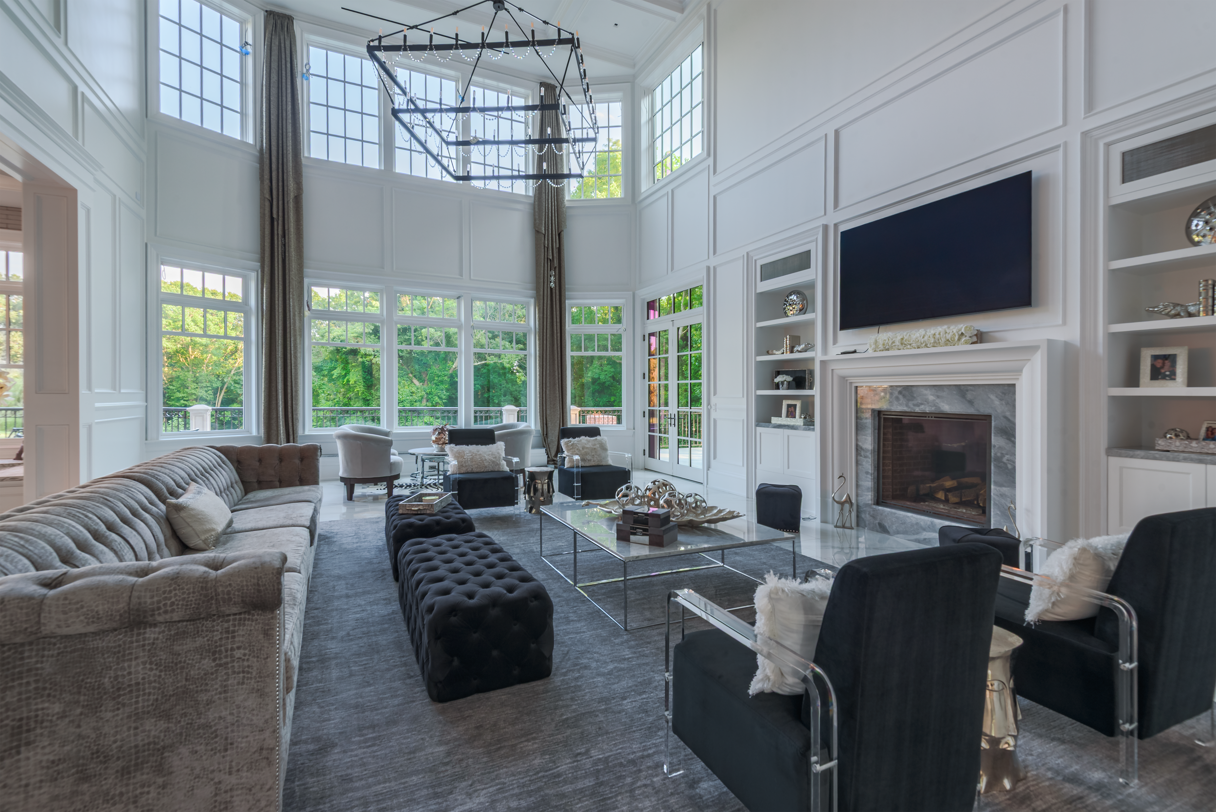 Large-scale architectural interior living room designed for commercial or luxury residential use, photographed in the NYC, Queens, and Long Island area with floor-to-ceiling windows and refined modern detailing