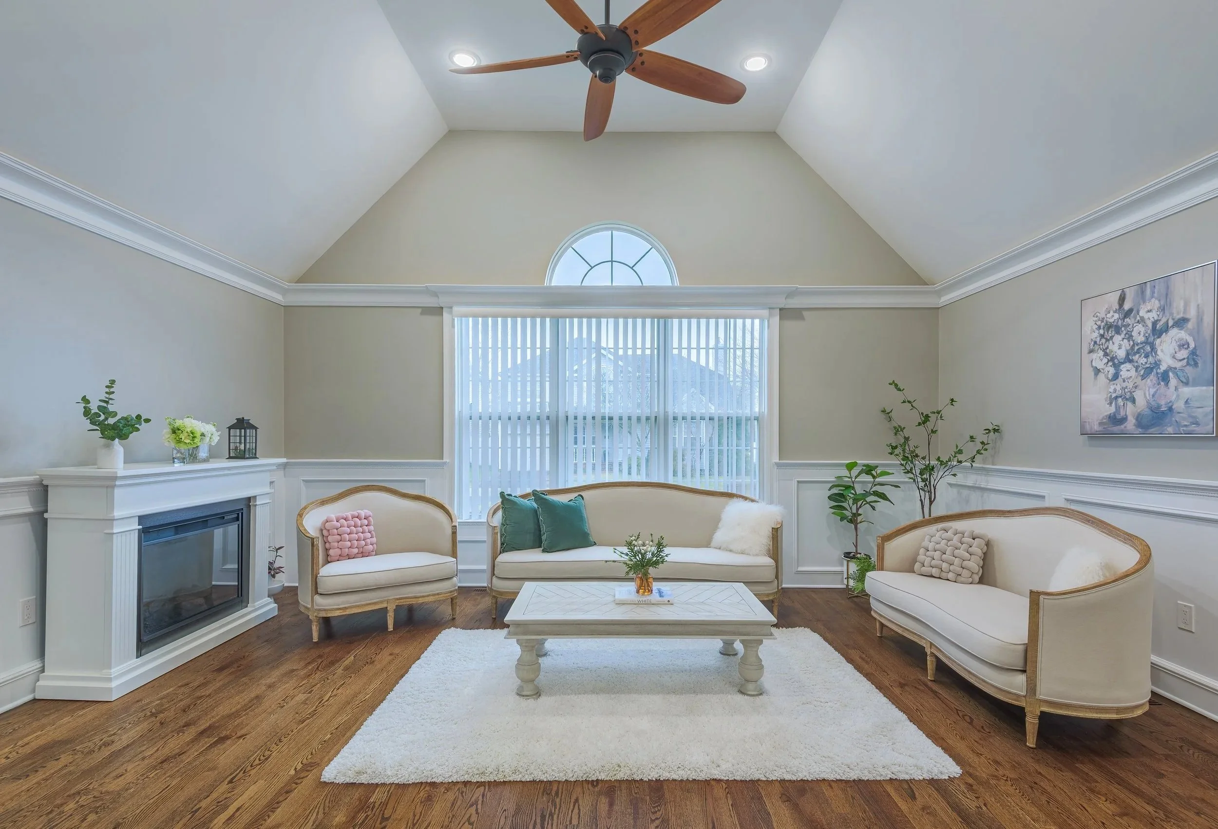 Elegant living room interior with vaulted ceiling, natural light, and neutral-toned furniture