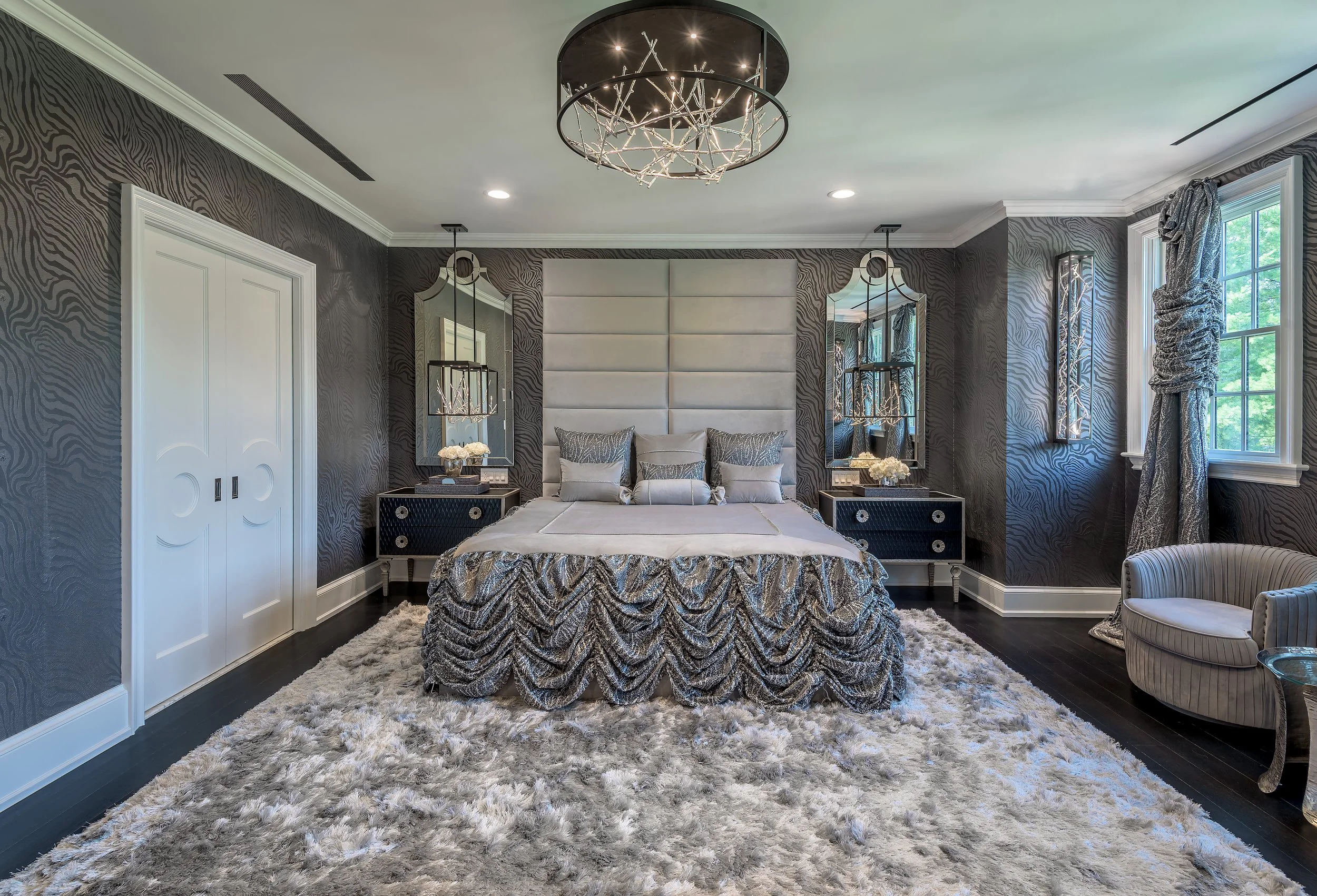 Luxury architectural bedroom interior featuring symmetrical layout, custom upholstered headboard, mirrored nightstands, and refined residential design
