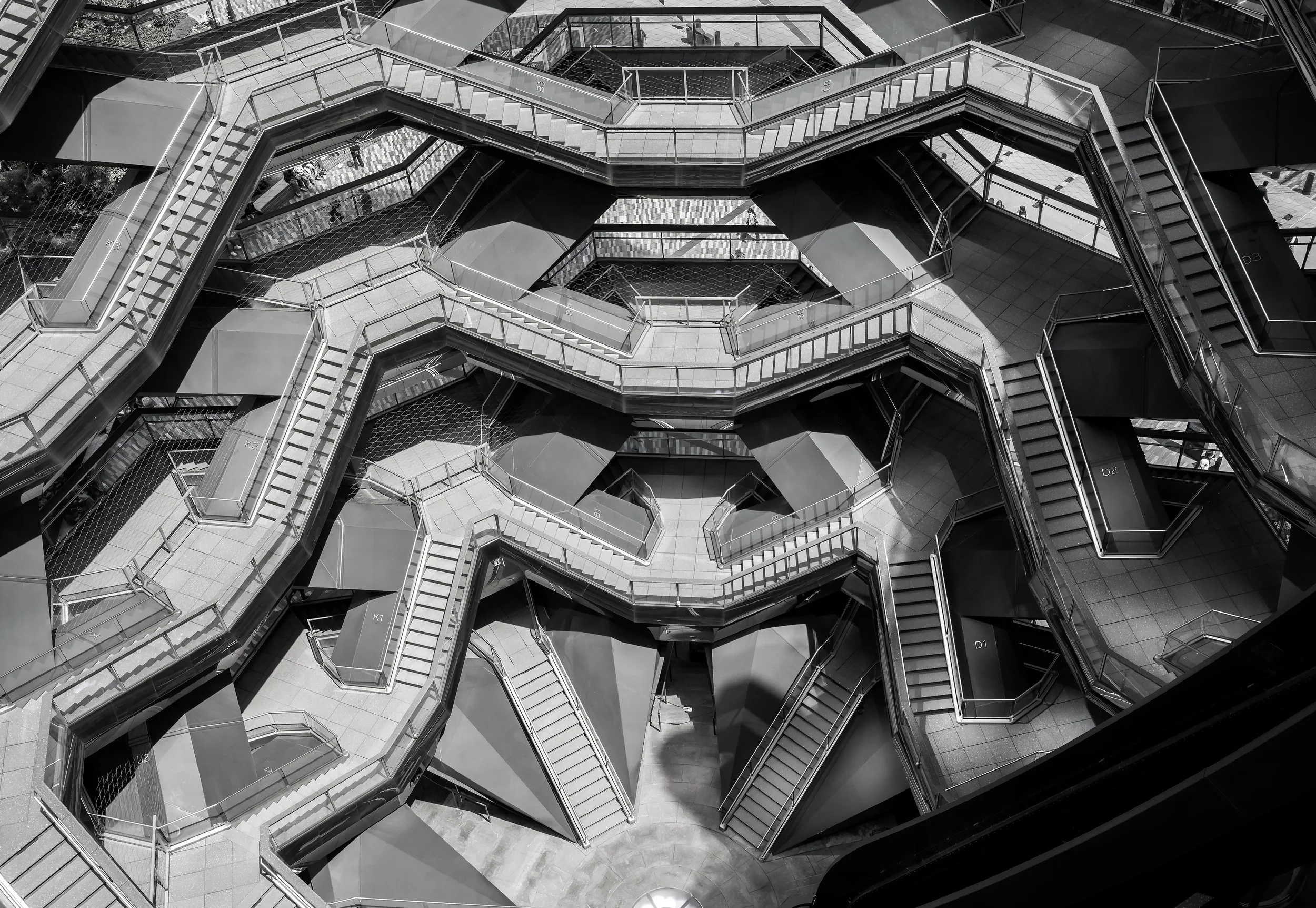 Black-and-white architectural photography study of the Vessel at Hudson Yards in New York City, focusing on geometric repetition, structure, rhythm, and urban abstraction by architectural photographer Ariel Palma.