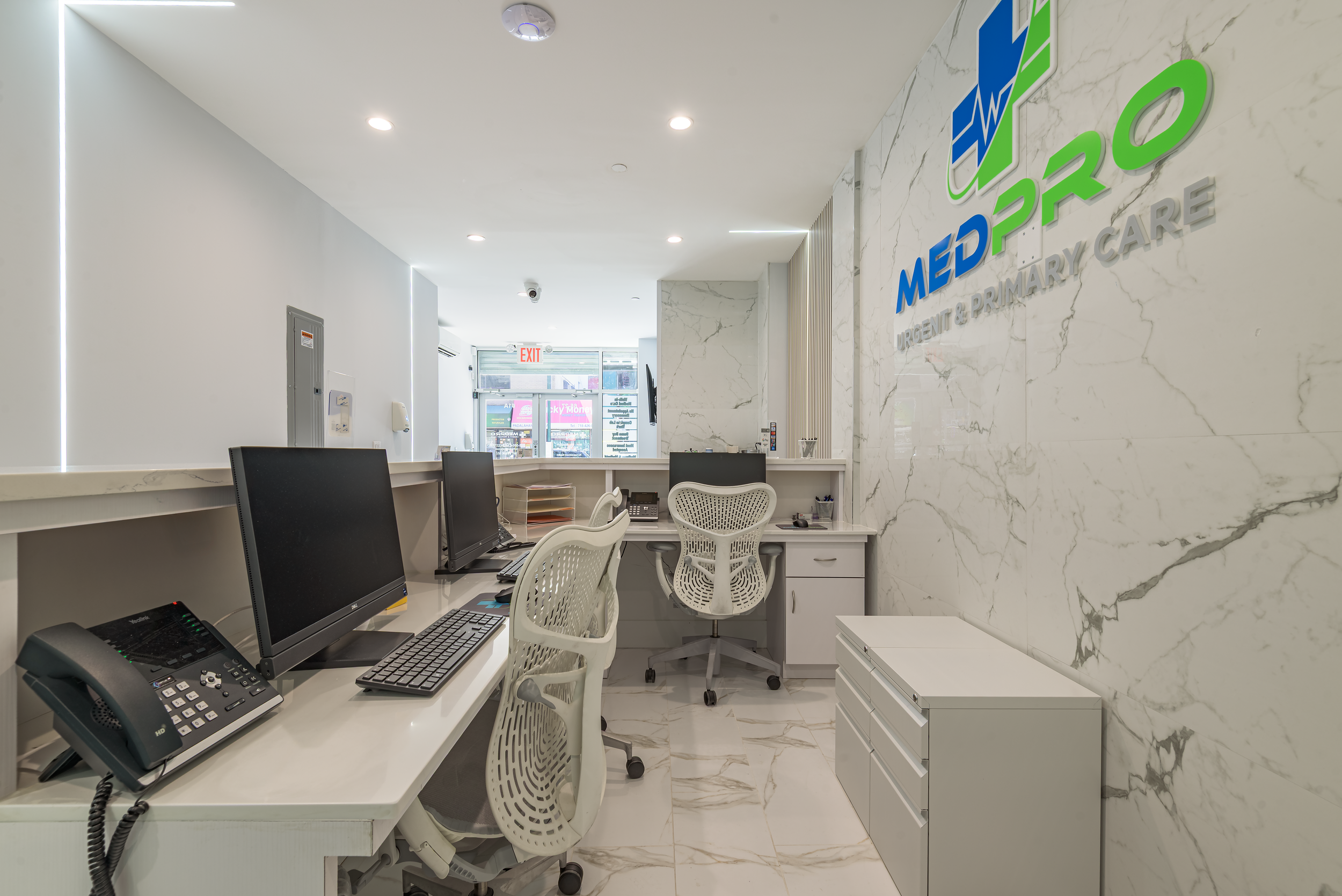 Modern medical office waiting room with clean architectural design, marble flooring, and reception desk, photographed for commercial healthcare interiors in NYC, Queens, and Long Island.