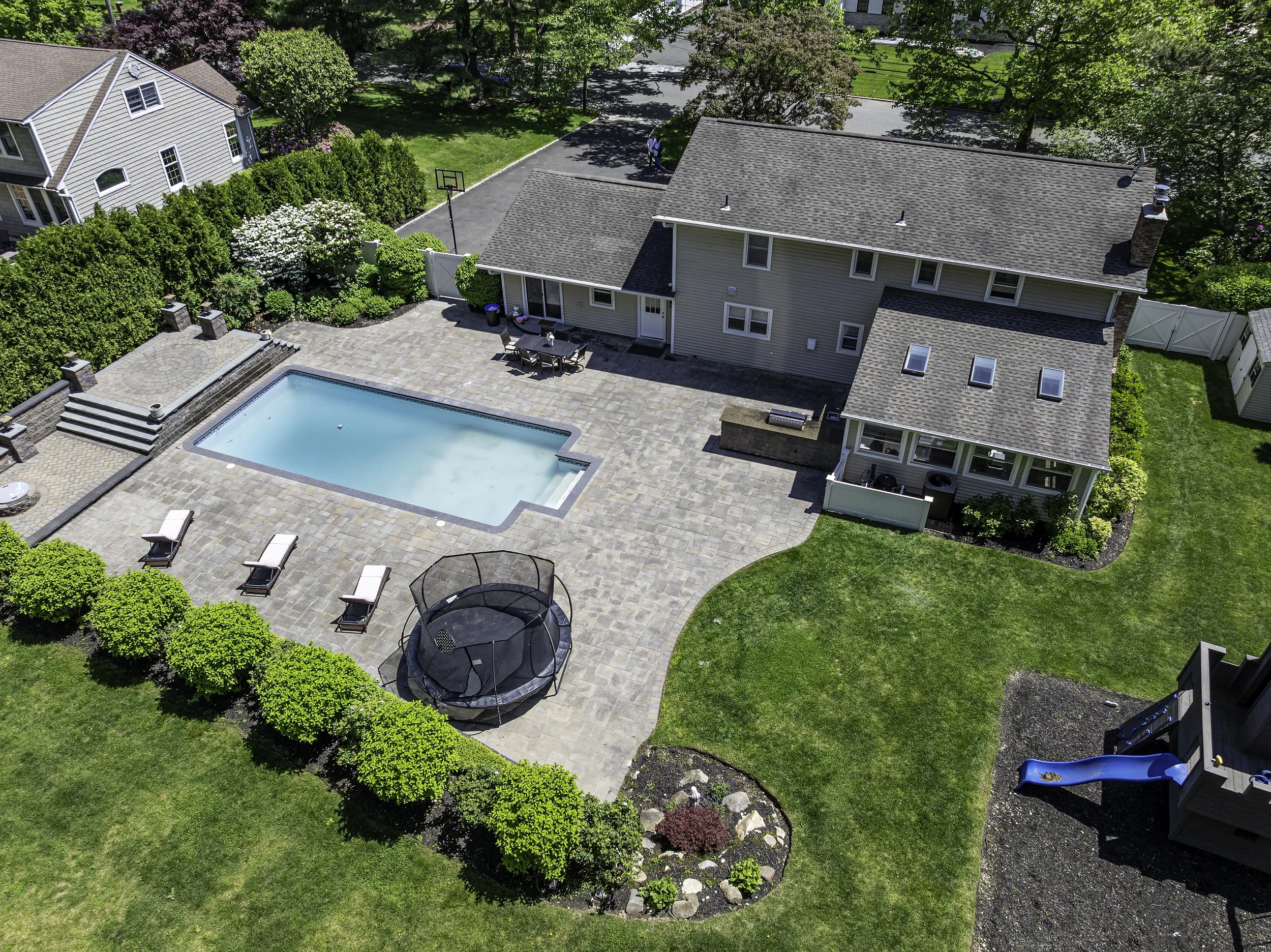 Aerial drone image of a home with pool and backyard for real estate photography.