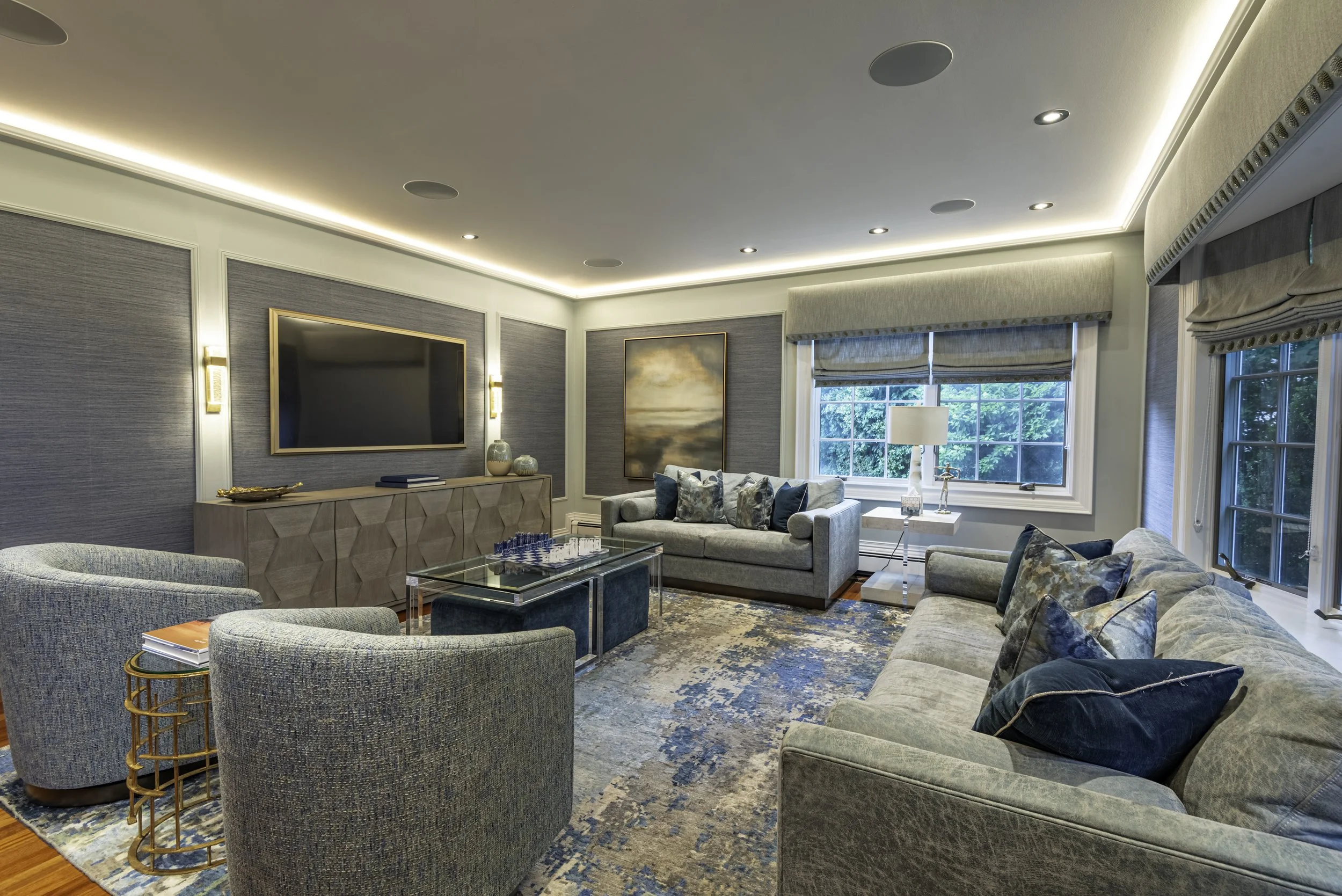 Professional real estate interior photography of a luxury modern living room with natural light, elegant furniture, and blue toned decor in New York.