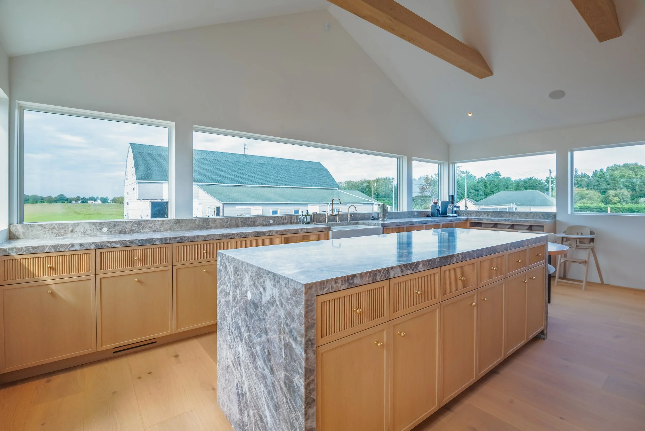 02-north-fork-gut-renovation-kitchen-marble-waterfall-island-white-oak-cabinets.jpg