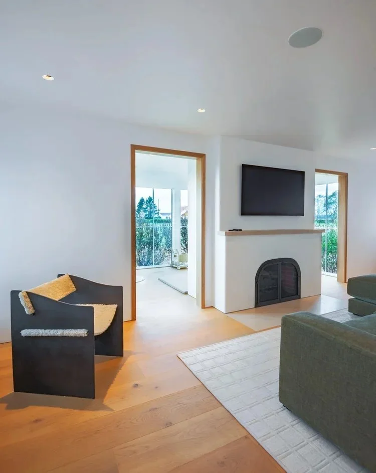 22-north-fork-gut-renovation-living-room-fireplace-sculptural-lounge-chair.jpg