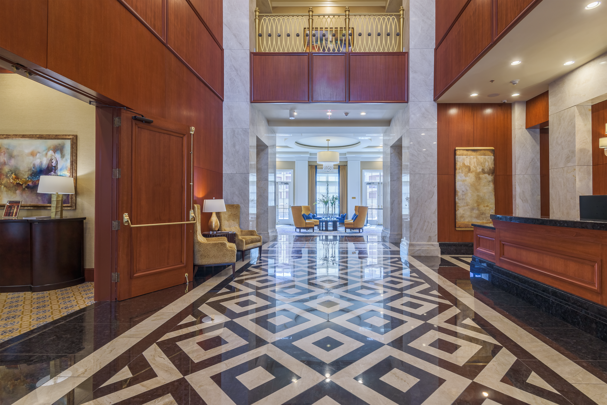 Elegant residential condominium lobby with chandelier and seating area at The Ritz, Long Island, New York