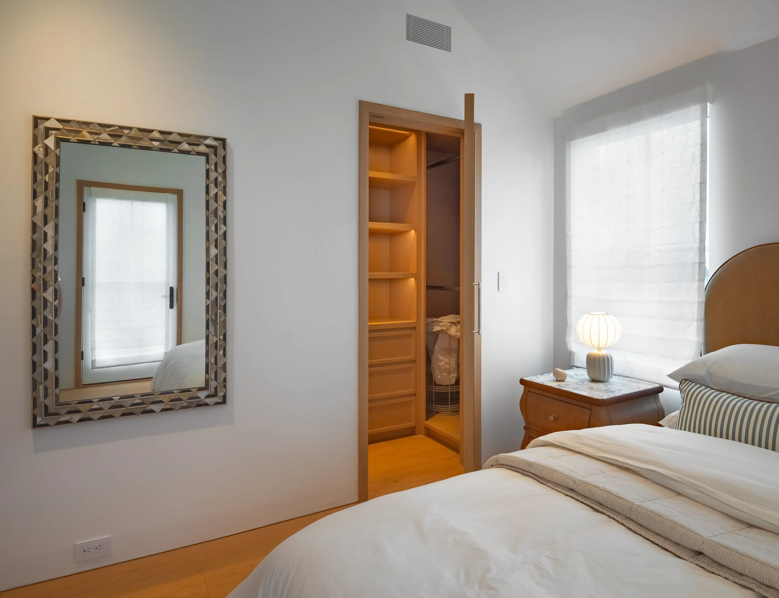 20-north-fork-gut-renovation-primary-bedroom-mosaic-mirror-lit-walk-in-closet.jpg