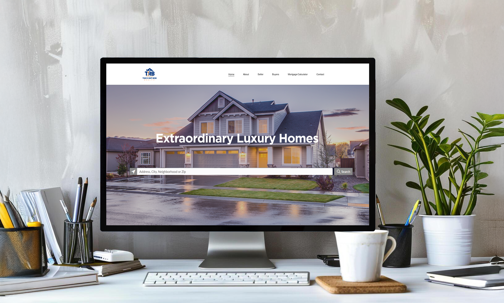 Computer monitor displaying a real estate website for luxury homes, showing a large house, search bar, and navigation options.