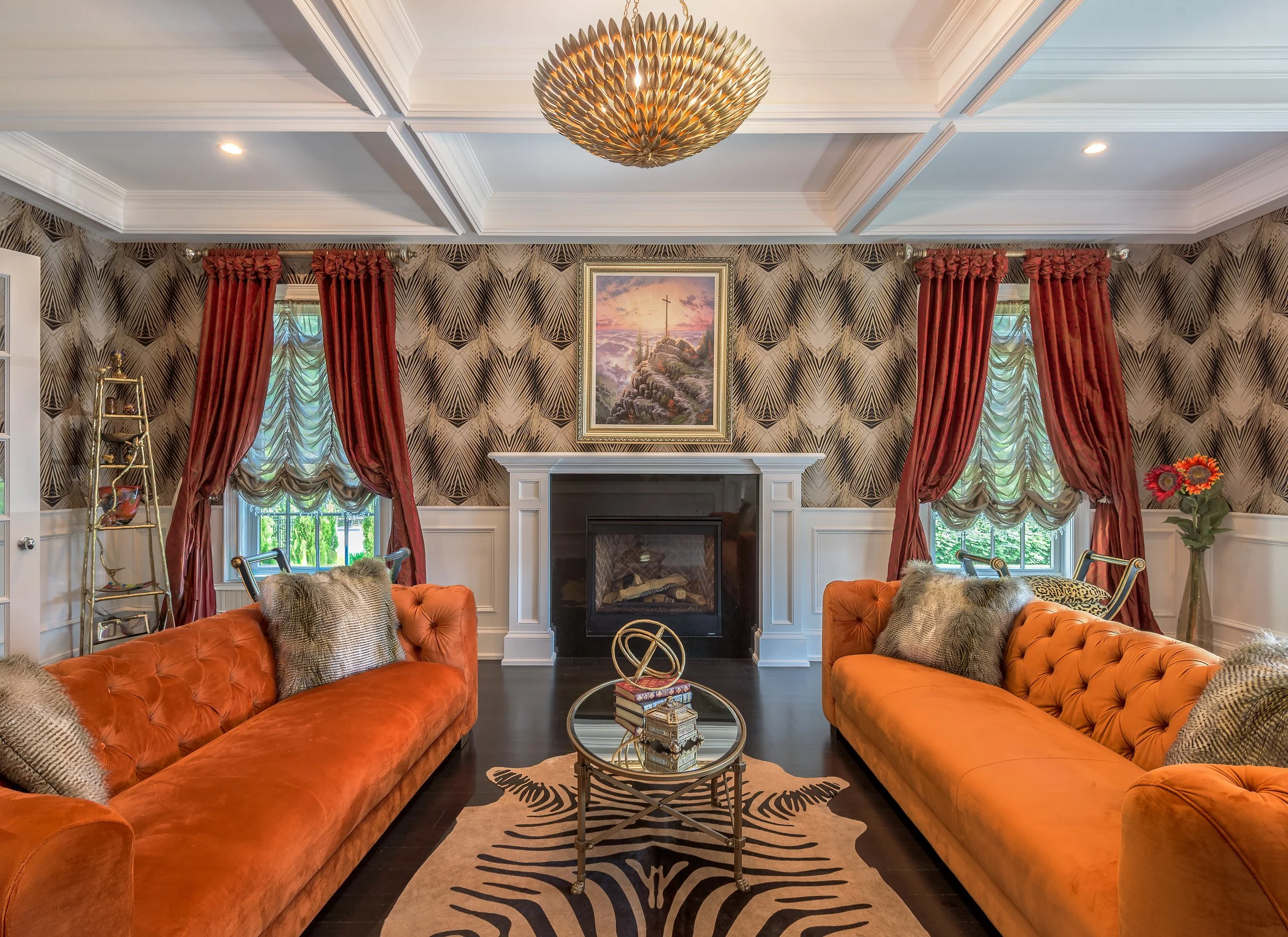 Architectural interior photograph of a living room with a fireplace, custom millwork, patterned wall coverings, and coordinated furnishings highlighting spatial balance and material detail.