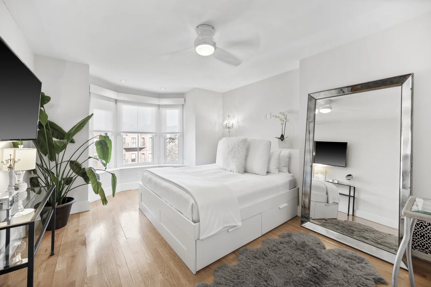 Bright white bedroom with bay windows